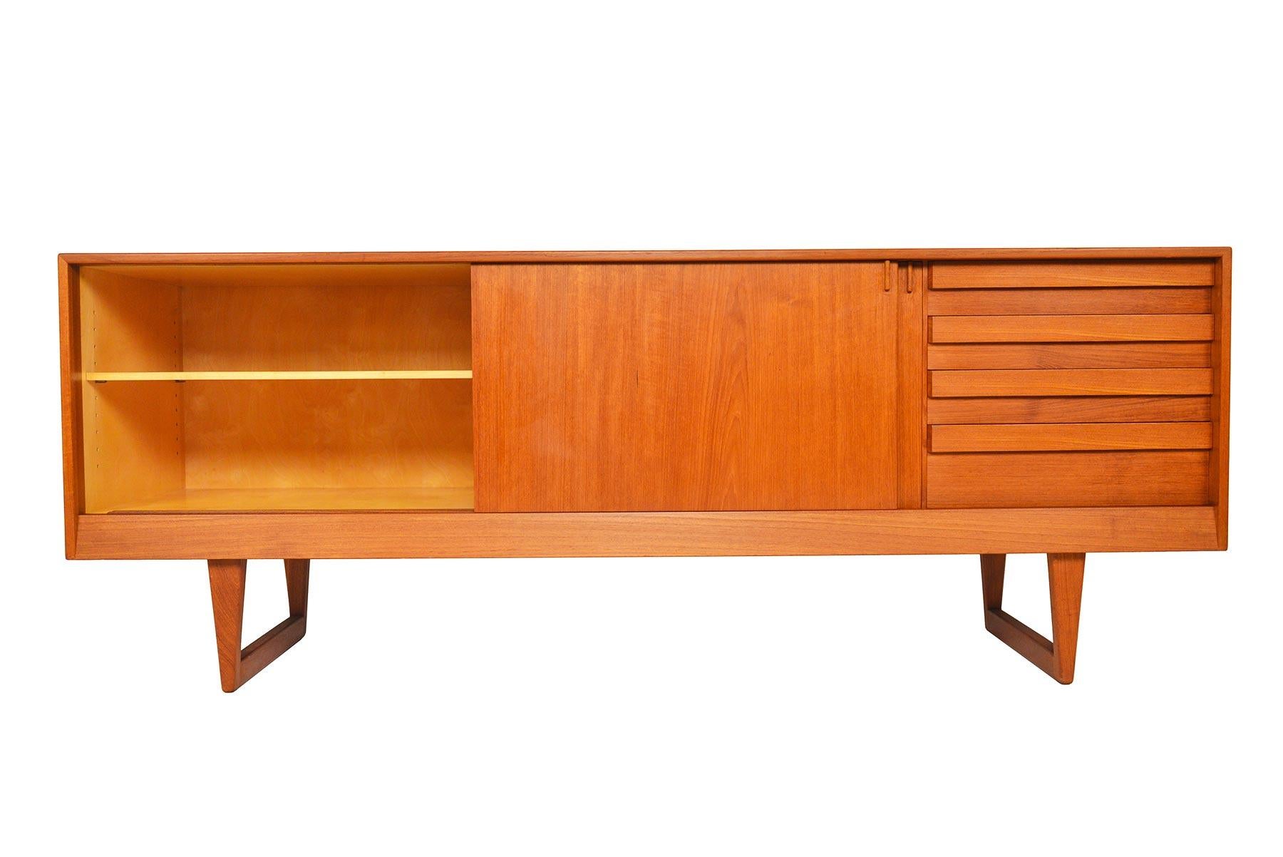 Taking angular design to the next level, this Danish modern credenza by Kurt Østervig for KP Møbler is a modern marvel. Two large sliding doors open to reveal three bays with adjustable shelving. A bank of four drawers with rectangular pulls are