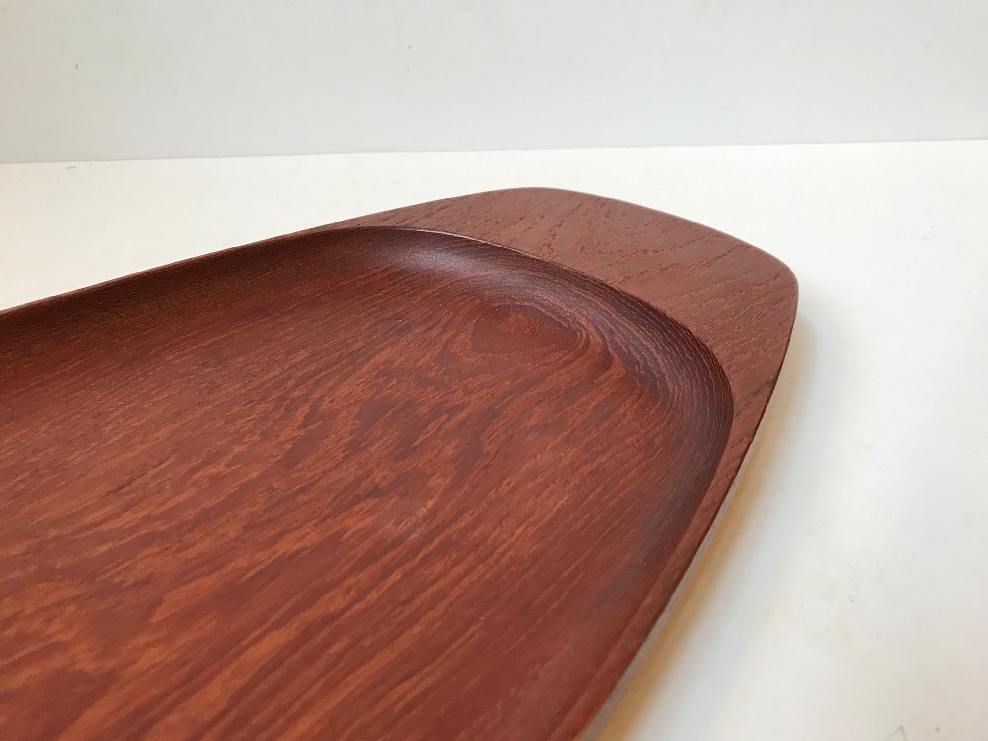 - A large organically shaped tray or dish
- Made from solid teak
- Manufactured and designed by Wiggers in Denmark, circa 1960 
- Reminiscent of the designs by Kay Bojesen and Finn Juhl
- Burn marked by the maker to the base.