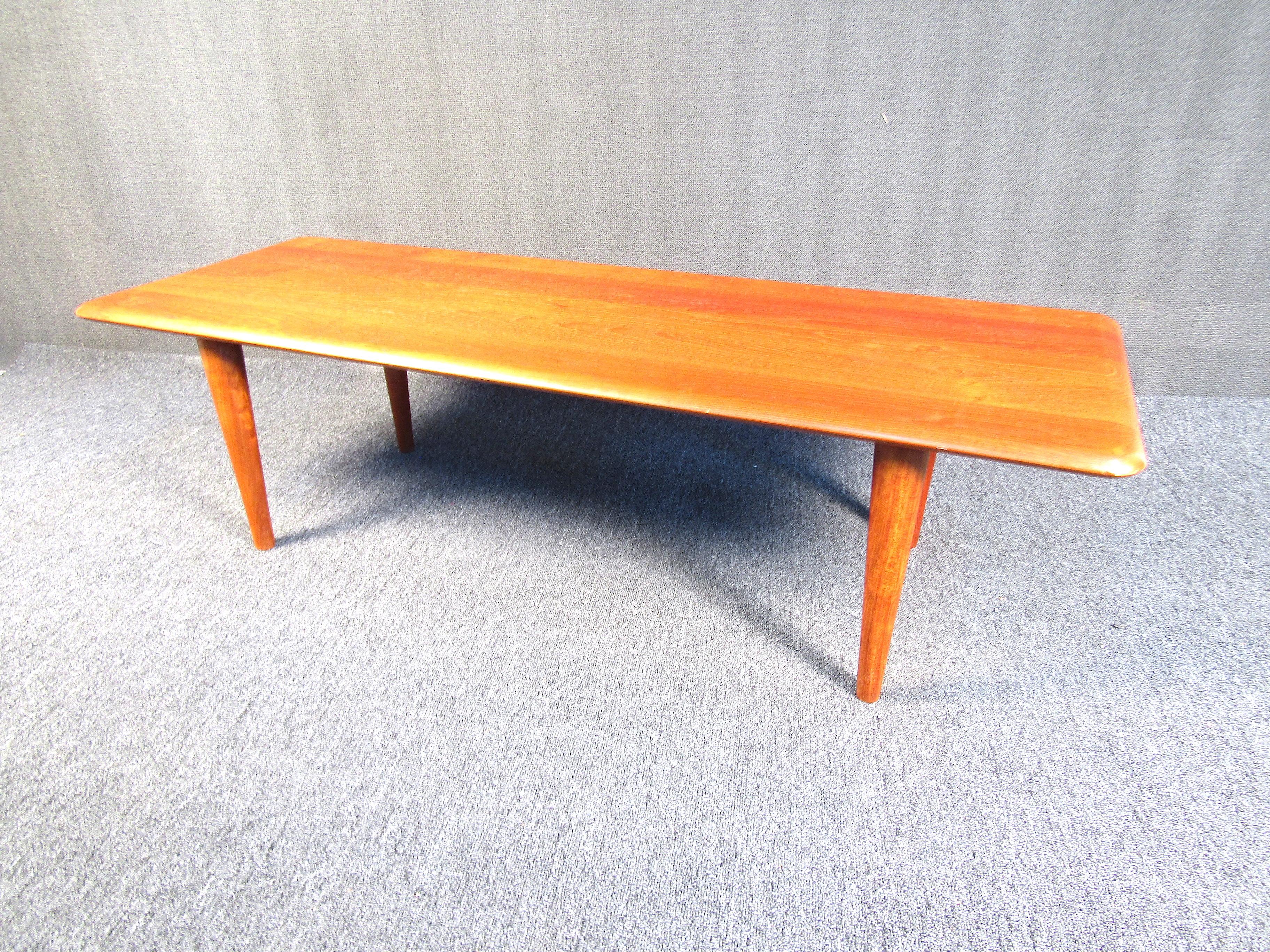 This beautiful teak wood coffee table is perfect for your living or sitting room. With deep wood grain patterns and ample surface space, this table is sure to make a statement. Please confirm the item location with the dealer. (NJ/NY).