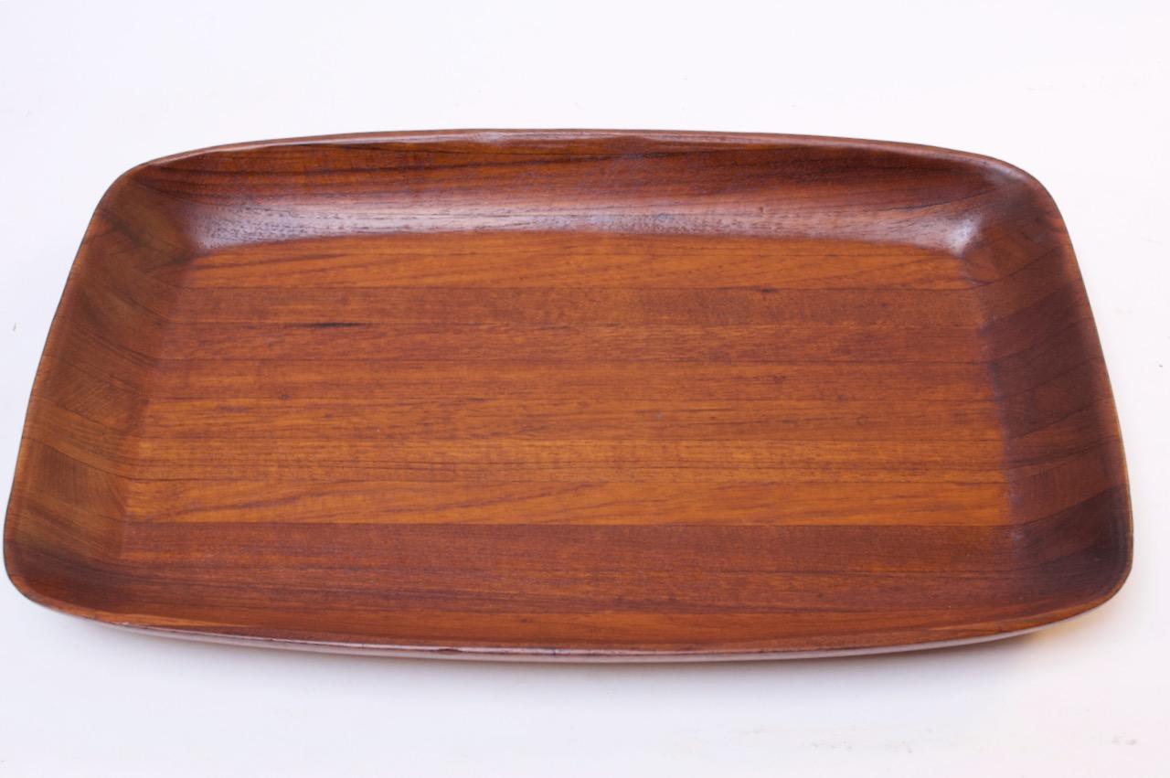 Ernest Sohn deep tray crafted from solid Siamese teakwood, circa 1960s. Unusual size for Sohn, mostly known for his smaller staved teak and enameled pieces (Measures: 12.25