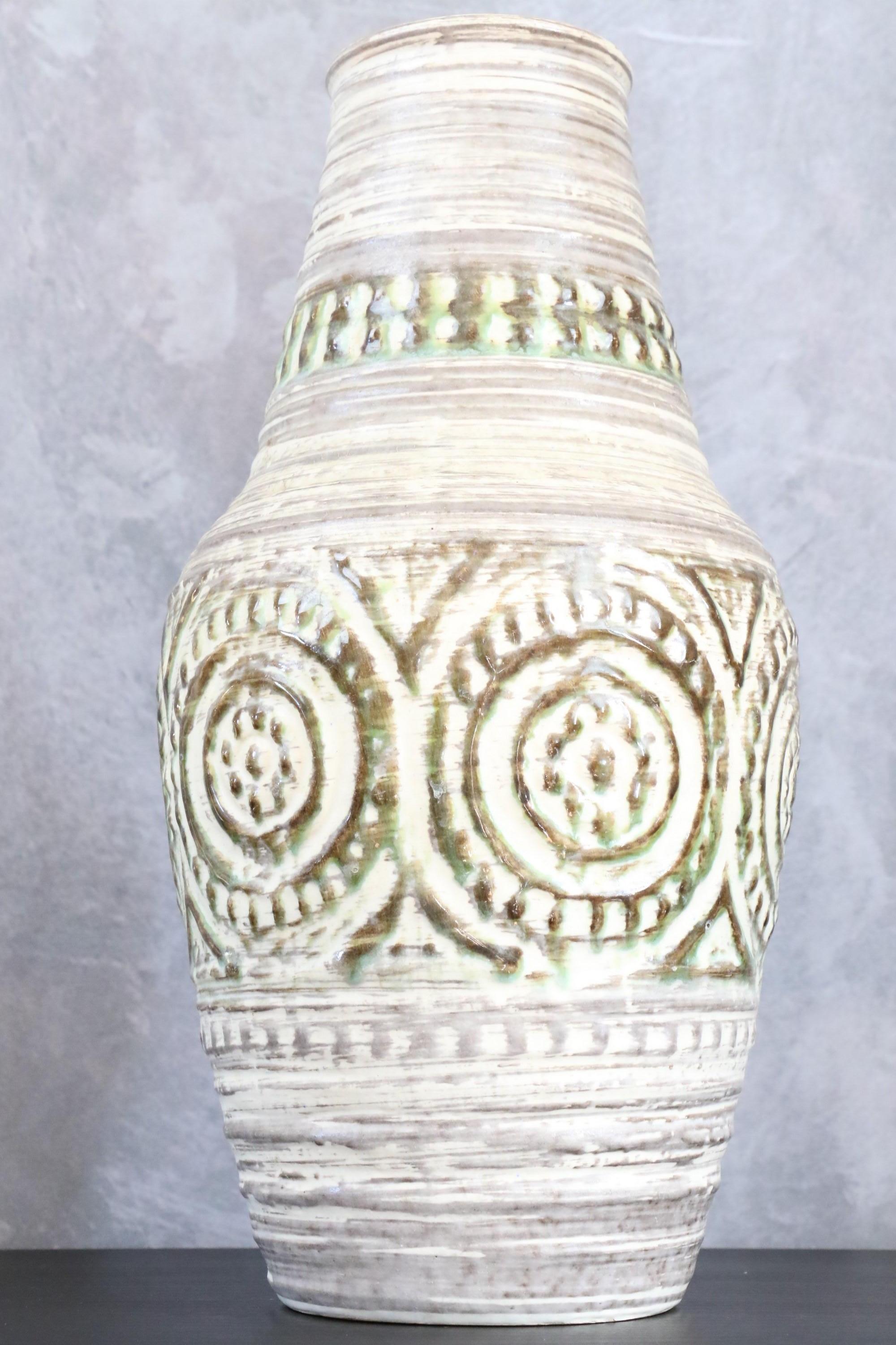 Large mid-century West Germany vase 116 33cm - grey ceramic vase - 1950s.

Ceramic glazed white-cream and decorated with circular patterns green slightly enhanced with brown.
The motifs in relief are slightly asymmetrical. This large vase is