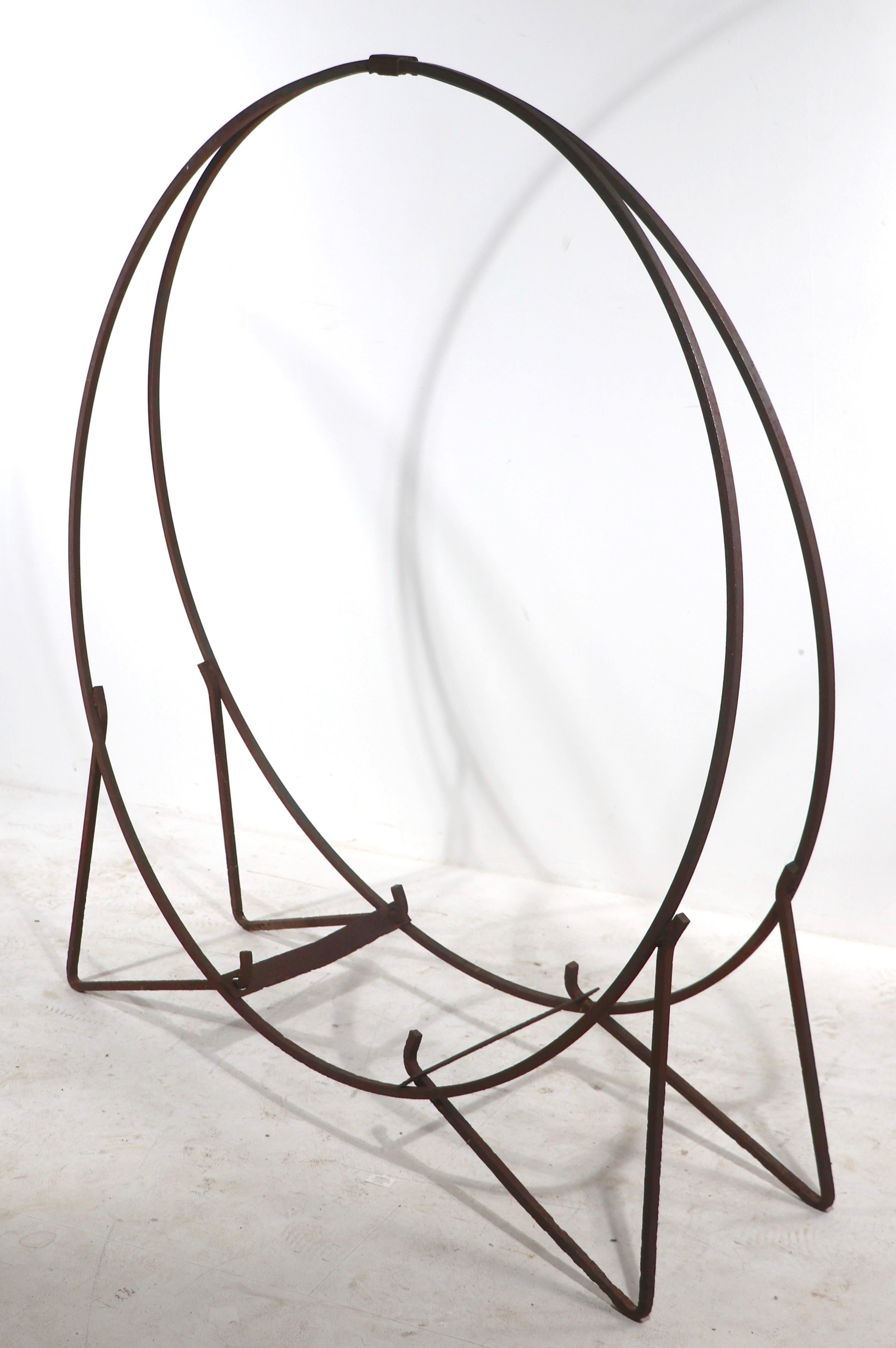 Nice big wrought iron log holder of solid stock wrought iron. This example is structurally sound and sturdy, it shows minor cosmetic wear and signs of use, notably slight bends to the crosspiece supports, normal and consistent with age and use. Nice