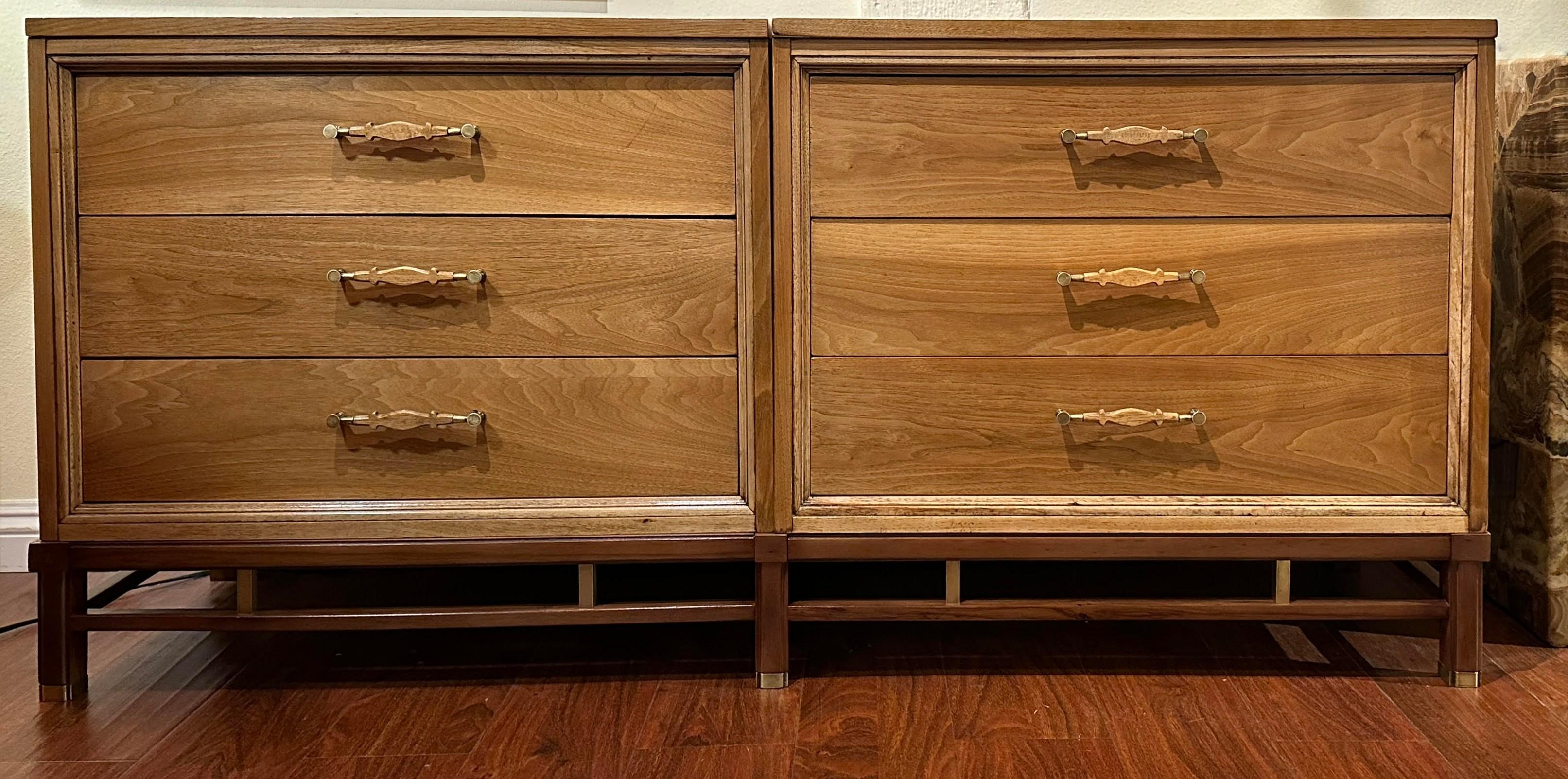 An elegant blonde walnut dresser by American of Martinsville catches the eye with its twin blocks of drawers resting on a slightly darker base. The designer ingeniously crafted these large dressers for easier maneuverability into smaller rooms. The