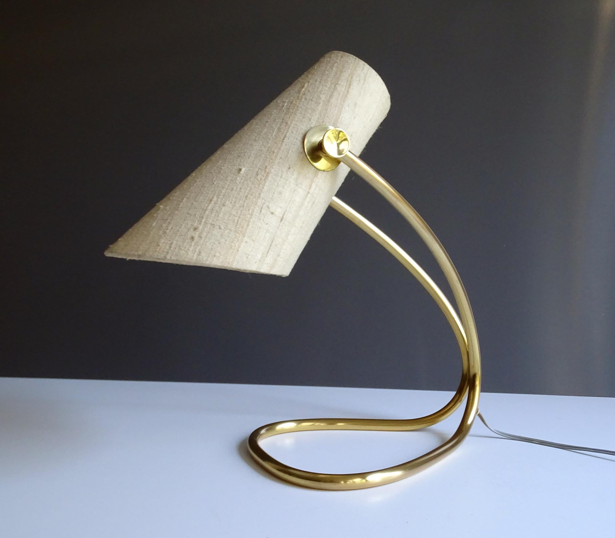 All our light´s electricals are professionally checked and tested for worldwide use
Extremely rare midcentury desk lamp by Nikoll Austria , featuring a continuous loop brass base, with concealed shade suspension, asymmetrical shade with two knoby