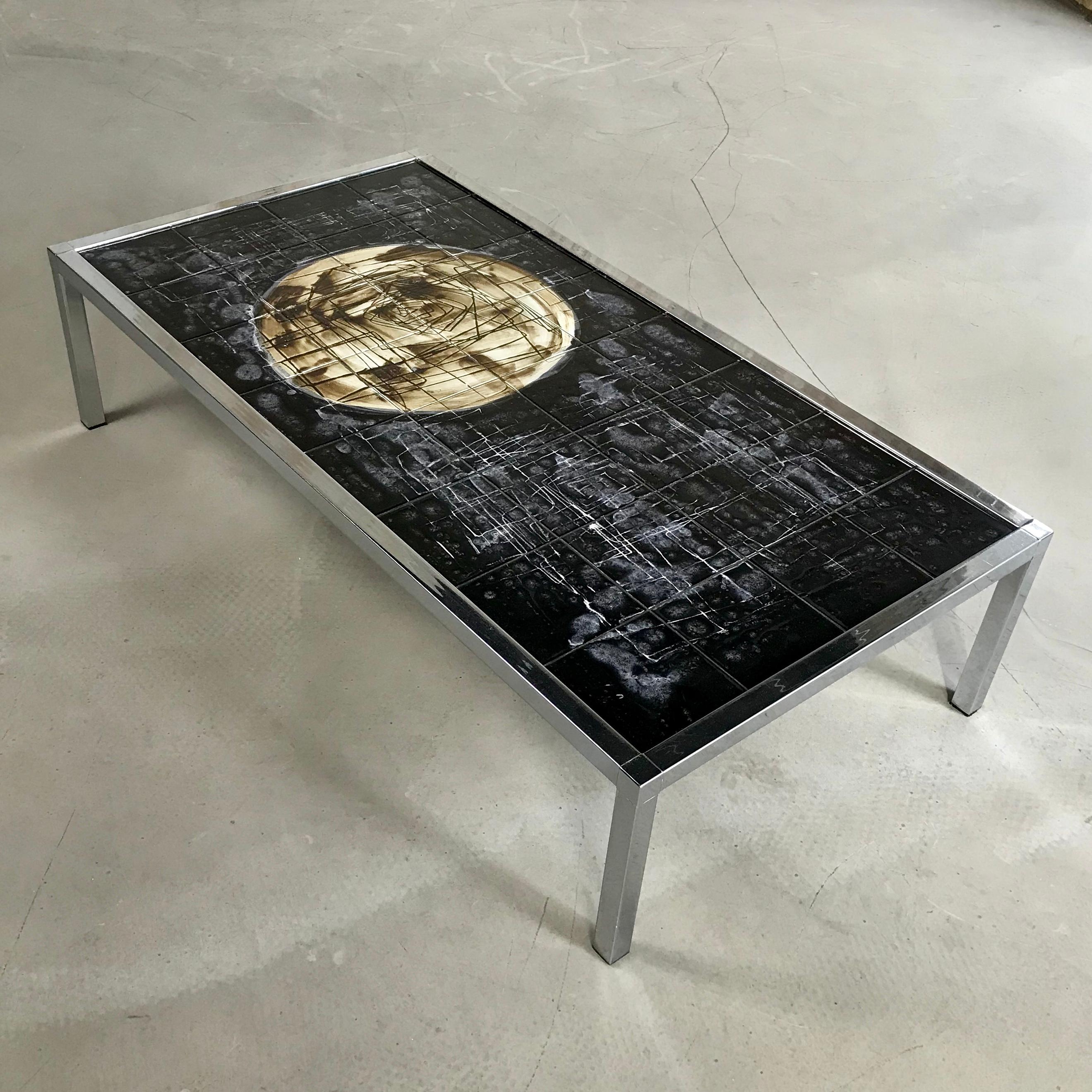 1960s Juliette Belarti large midcentury coffee or side table featuring handmade ceramic tiles supported by a chrome frame. The table makes a strong statement and is a guaranteed conversation piece.

Belgium ceramic artist Juliette Belarti (a pun