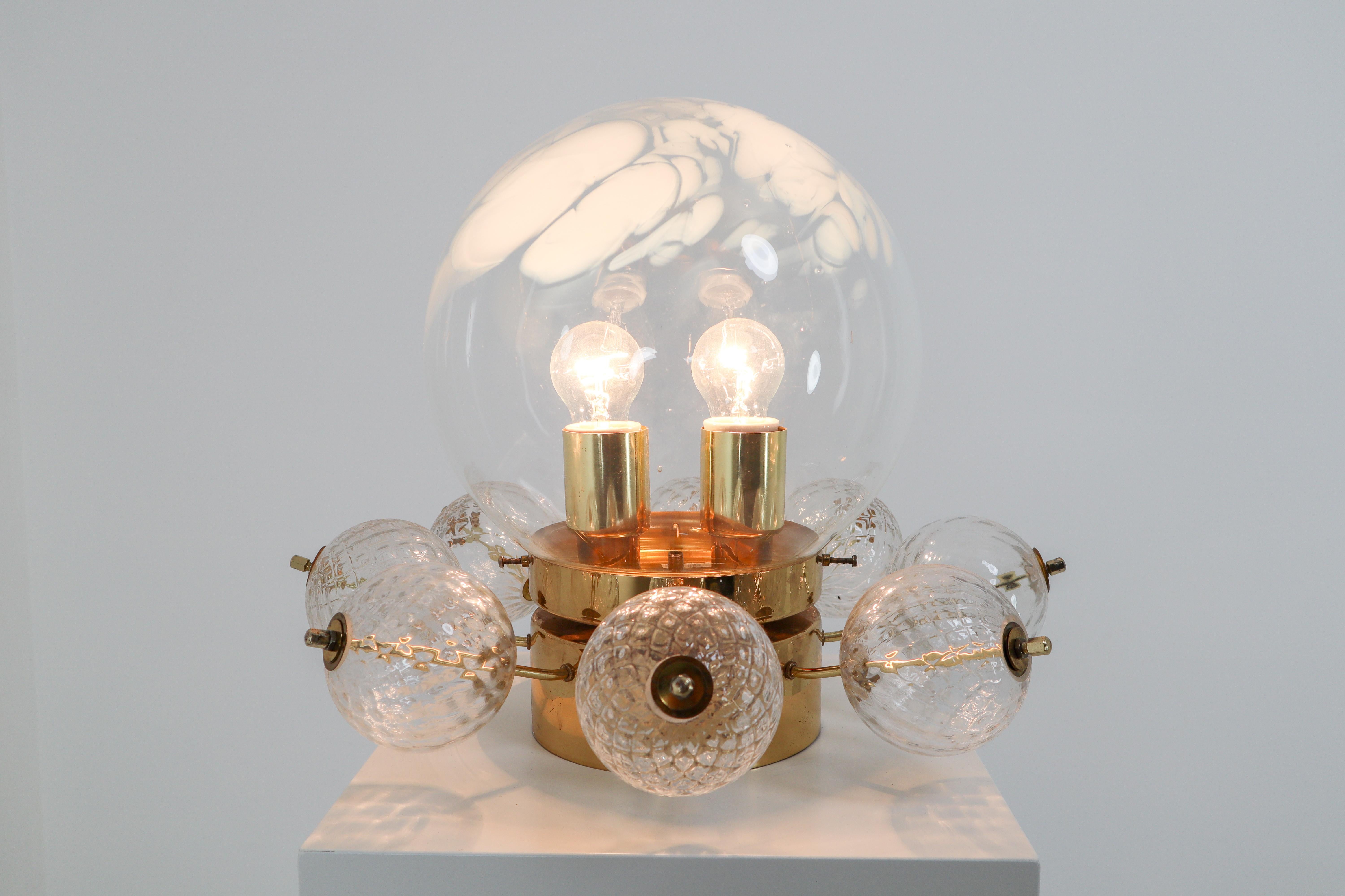 Large ceiling lamp-chandelier with brass base and large handblown art-glass globe. These clear handblown glass globe are decorated with white streaks. The globe show a different and unique semi transparent, diffuse surface, which looks wonderful.
