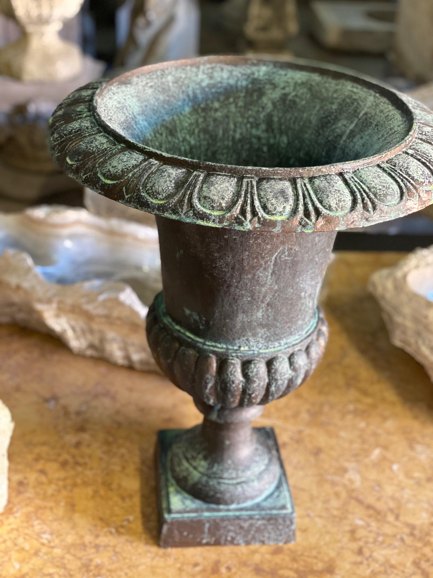 This contemporary urn features a iron / rust exterior to add charm to a garden or landscape.

Measurements: 19