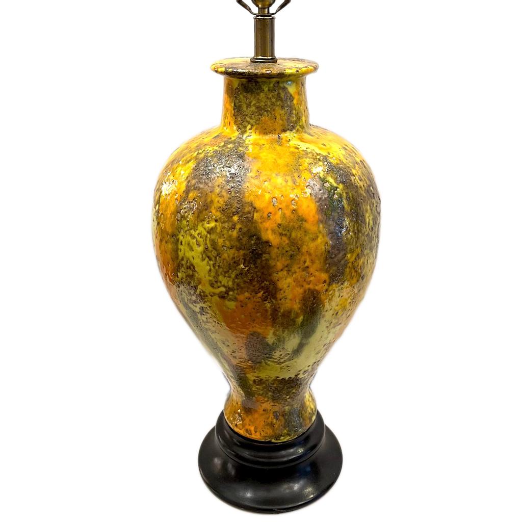 A circa 1960's Italian ceramic lamp with wood base.

Measurements:
Height of body: 21.5