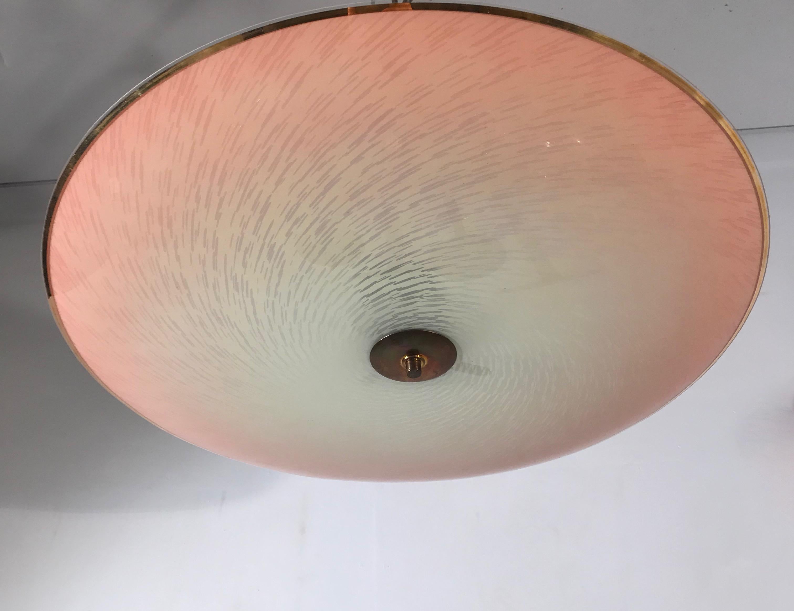 Beautiful shape and materials pendant from the Mid-Century Modern era.

This rare shape and large size flush mount has a stunning, glass shade with a striking, hurricane-like pattern. As you can see, the artistic and almost flat glass shade comes
