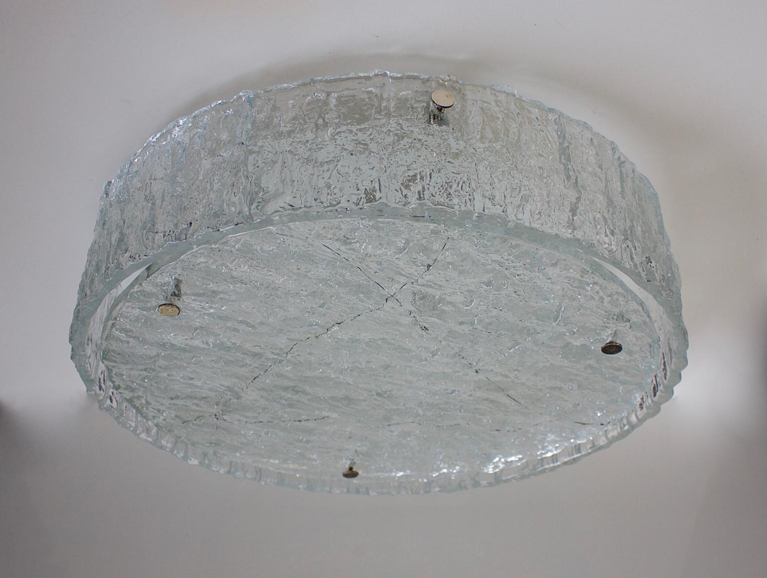 Large midcentury circular drum-shaped flush mount light by Kaiser Leuchten, Germany, 1960s. 

The glass shade comprises two elements of heavily textured clear glass pinned to a white metal frame with screw-in metal fixings. The sides of the shade