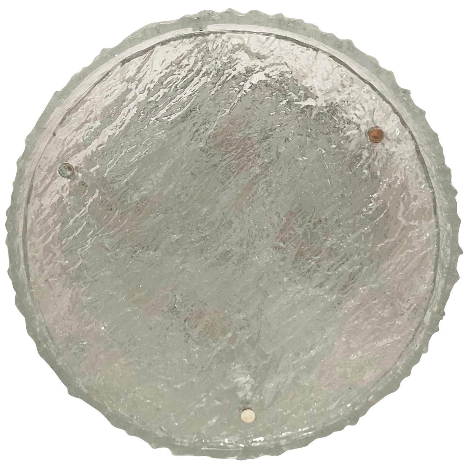 A large circular flush mount or wall light by Kaiser Leuchten, Germany, 1960s.
The light fixture is made of two thick textured  glass elements and white metal frame.
Socket:  4 x  E27 or E26 (for US) for standard screw bulbs.
