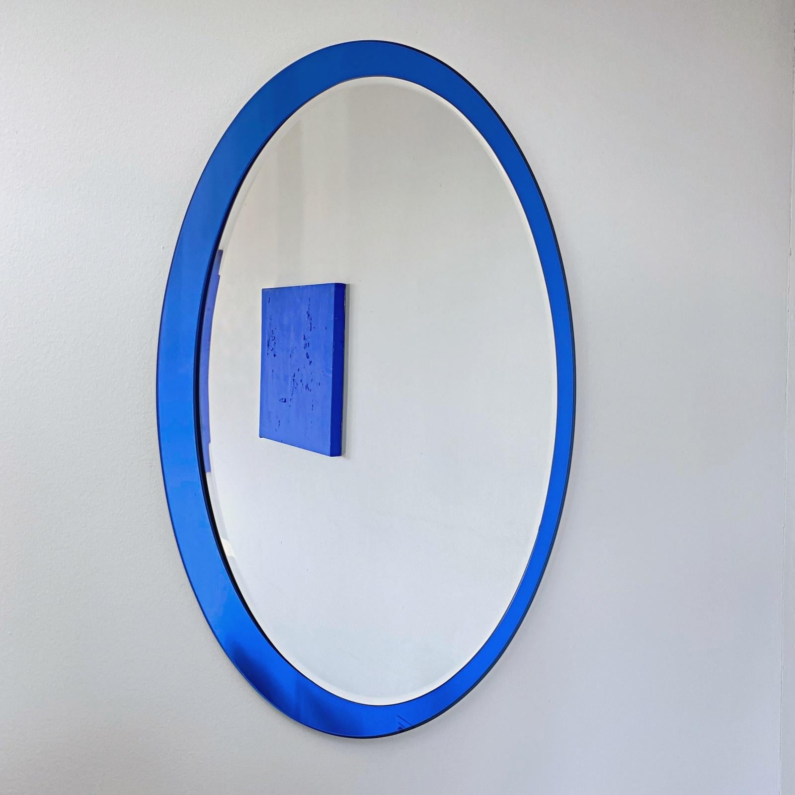 Beautiful Fontana Arte labeled cobalt blue edged wall mirror made in 1960s, Italy. The mirror can also be hung horizontally. The mirror is in a very good condition, without any chips or scratches.

Dimensions:
H 81 cm / 31.9 in
W 58 cm / 22.8