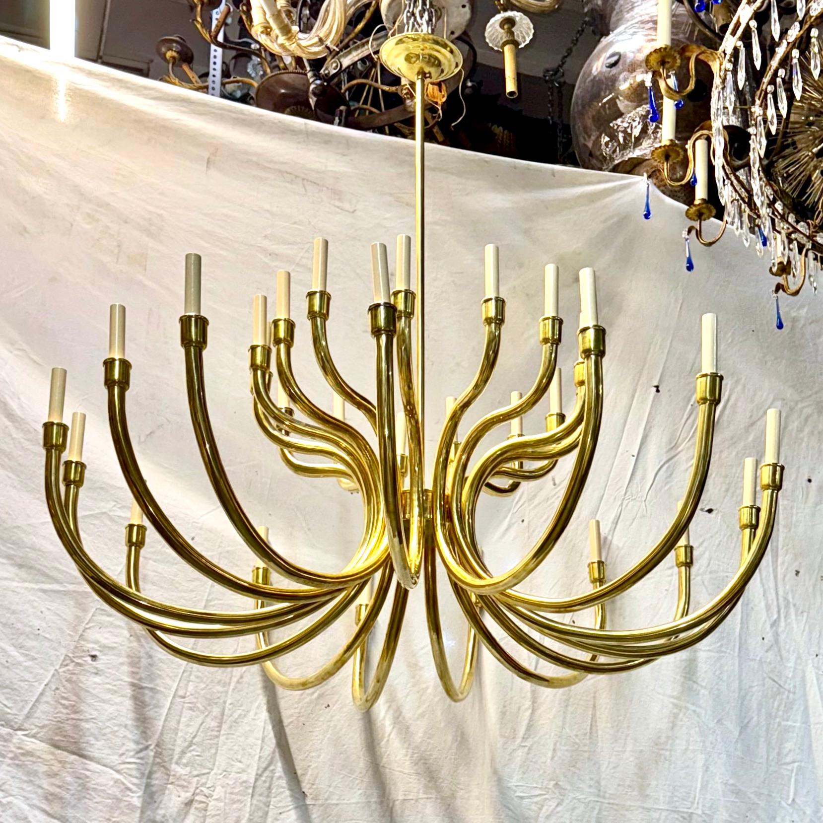 A circa 1960's French polished bronze chandelier with 28 lights.

Measurements:
Current drop: 50