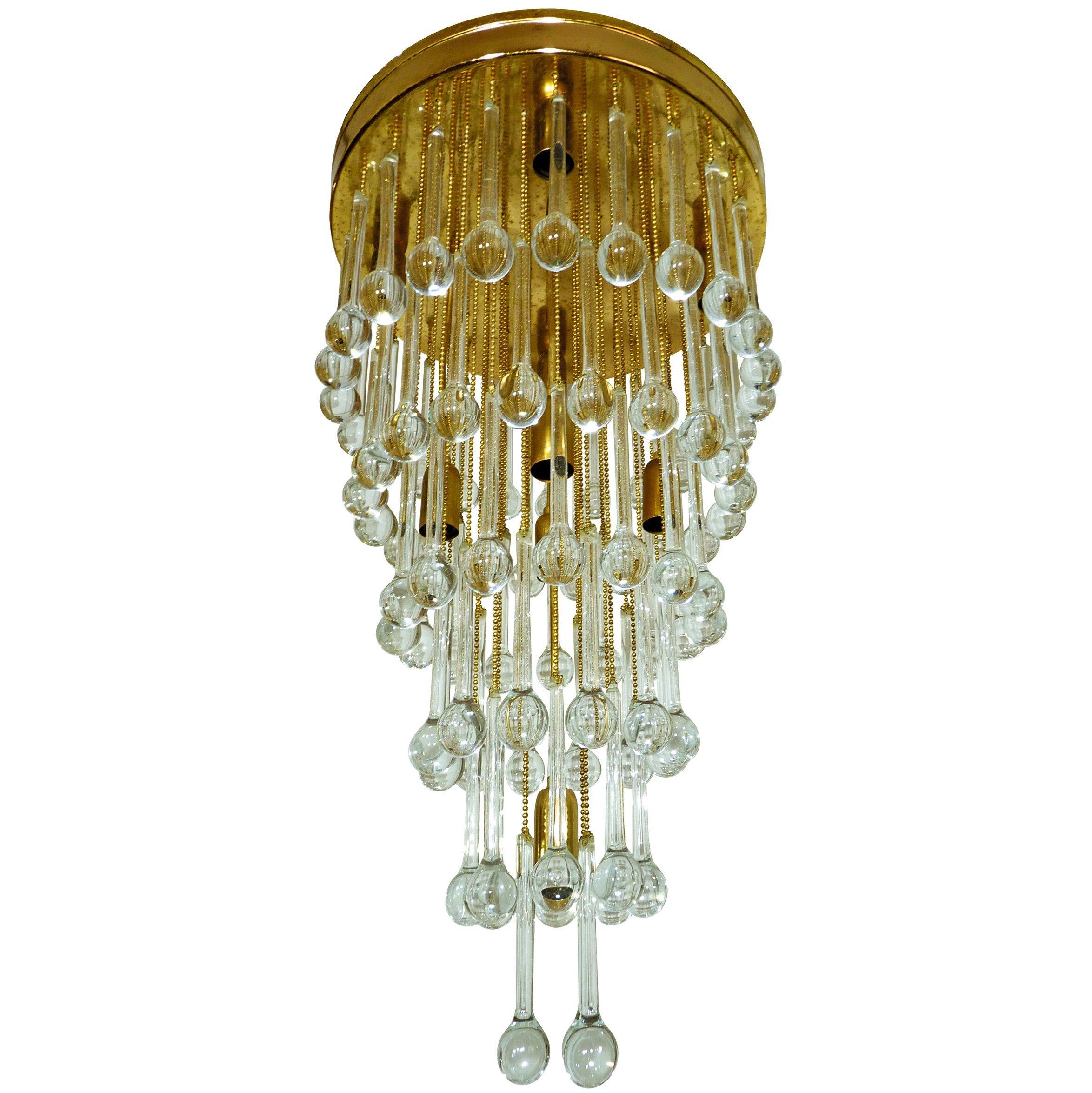 Stunning crystal waterfall wedding cake chandelier with nine-light flushmount chandelier, attributed to Ernst Palme. The piece is gold-plated and detailed with six layers of clear crystal elongated teardrop shaped prisms.
Measures:
Diameter 16 in /
