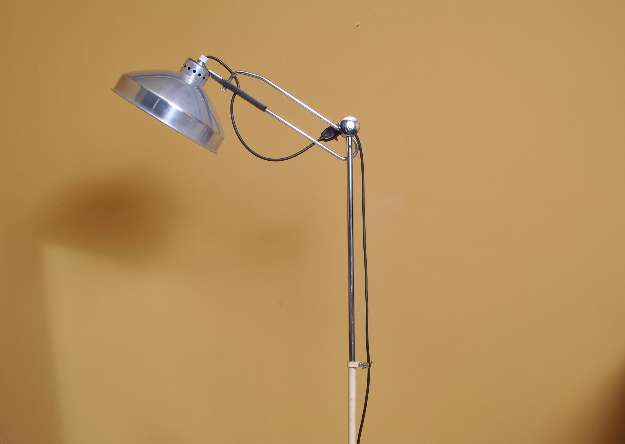 A substantial midcentury Industrial floor lamp. An incredible piece with solid cast iron base, long chrome arm and fittings with a large polished aluminum head. This lamp is fully adjustable in all directions.
  