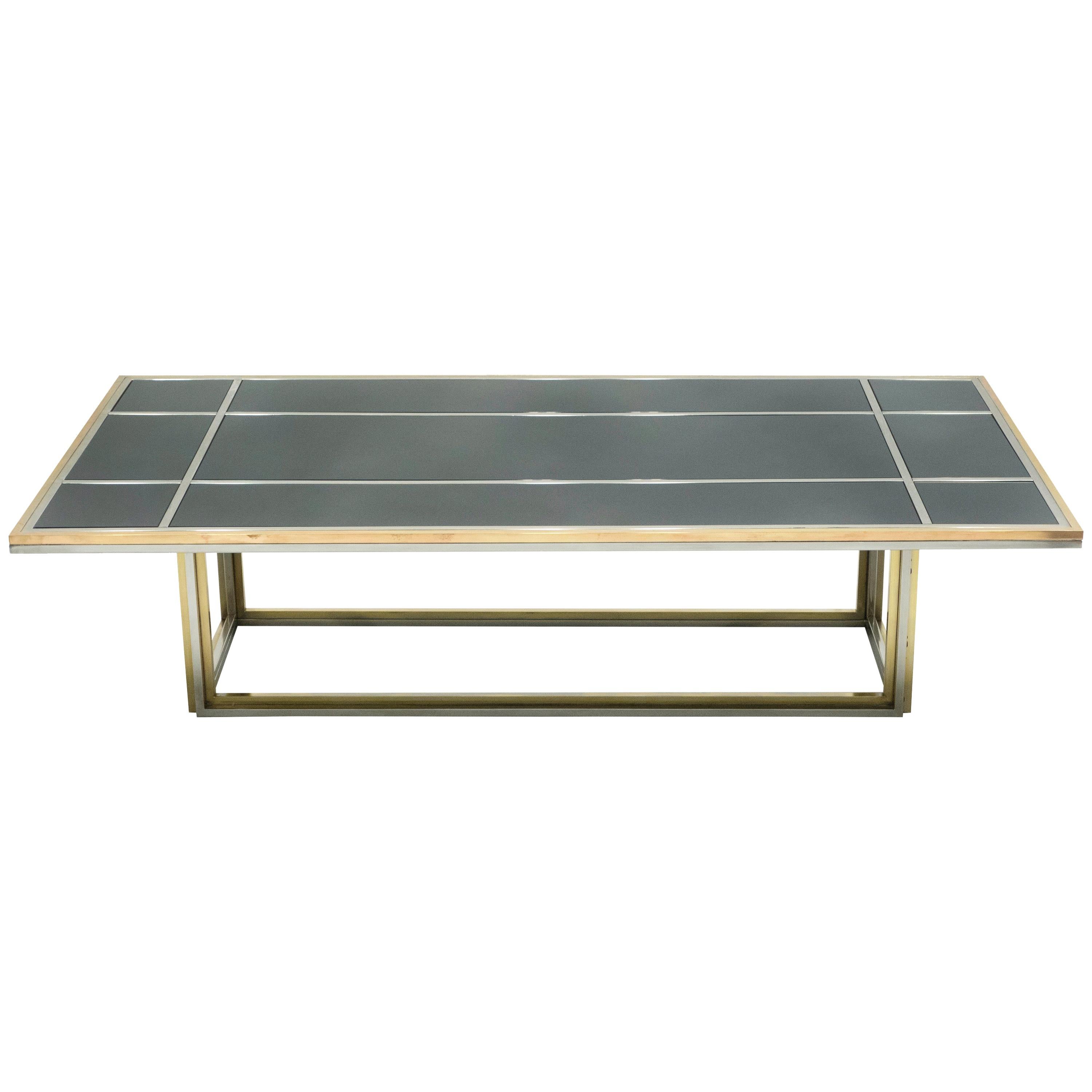 An intriguing piece of design, this coffee table deserves to be the focal point of a room. Symmetrical brass and chrome elements strike through a black opaline glass top, the result being an impressively sleek living room centerpiece. Made in Italy