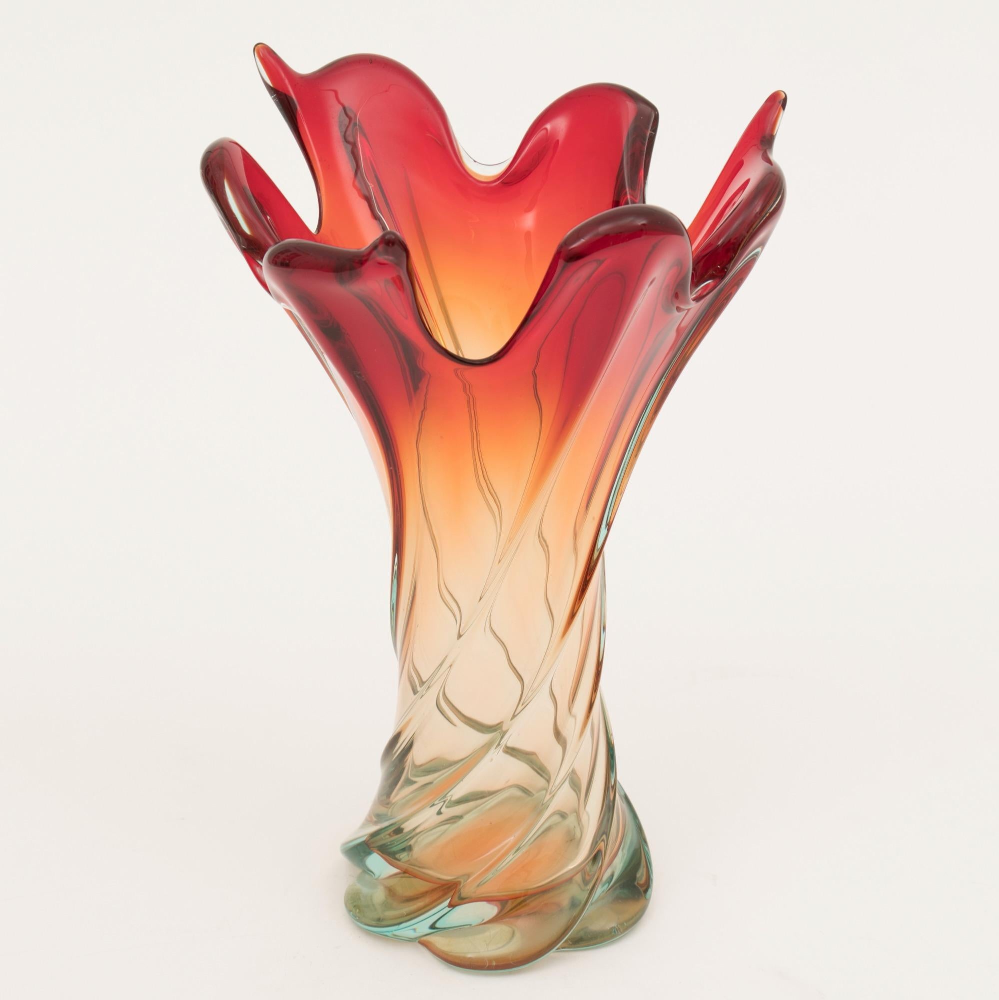 A impressive Italian midcentury Murano swirl vase in red, amber and blue glass.
with a flame effect reaching up.
Still has the original Murano label
circa 1960.
Measures: H 35cm, W 25cm, D 25cm.