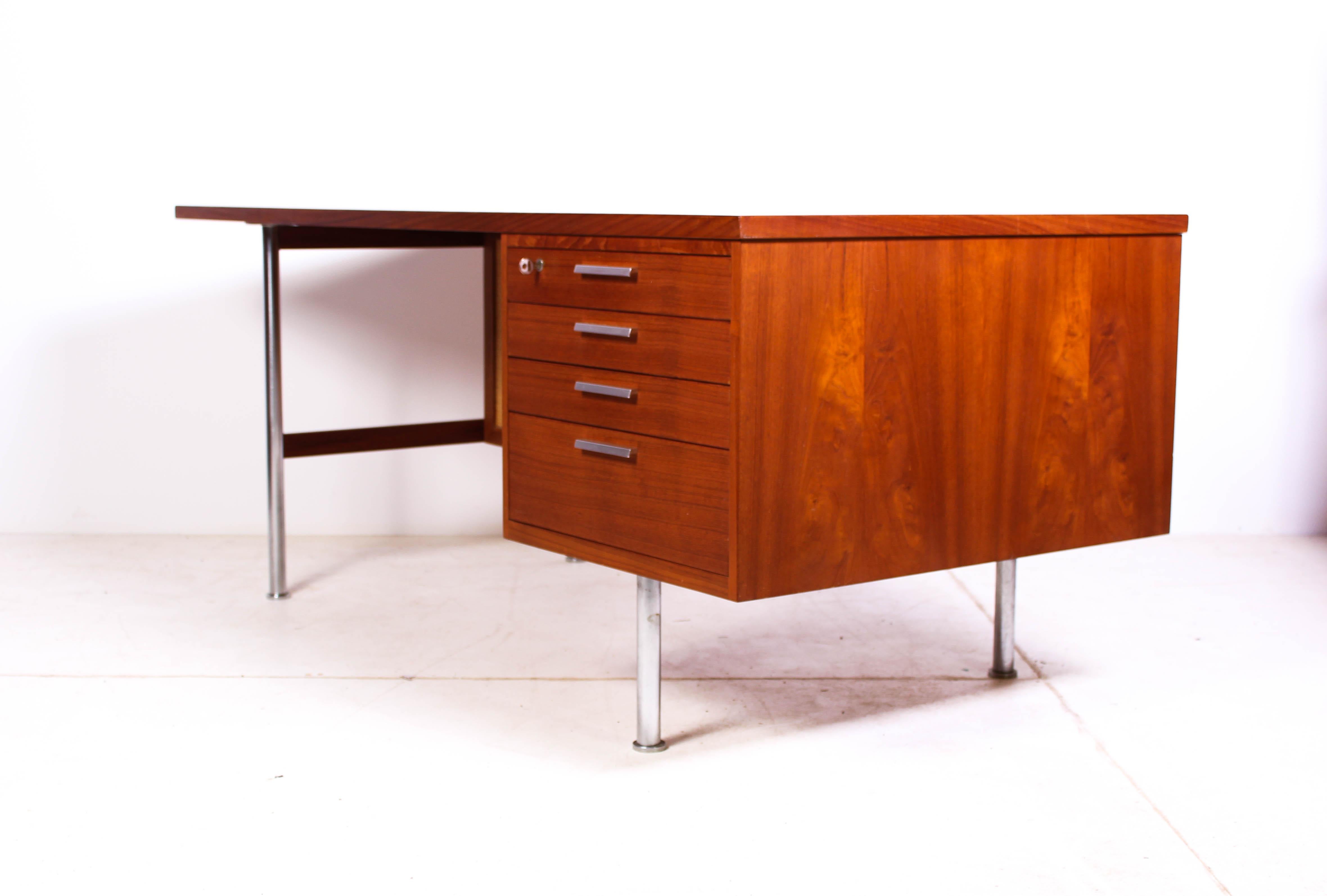 This rare midcentury desk is designed by Danish designer Kai Kristiansen and produced by FM Møbler. The desk is made out of teak with chromed steel legs and cane. It has drawers in the front and a open shelf in the back. This high quality piece is