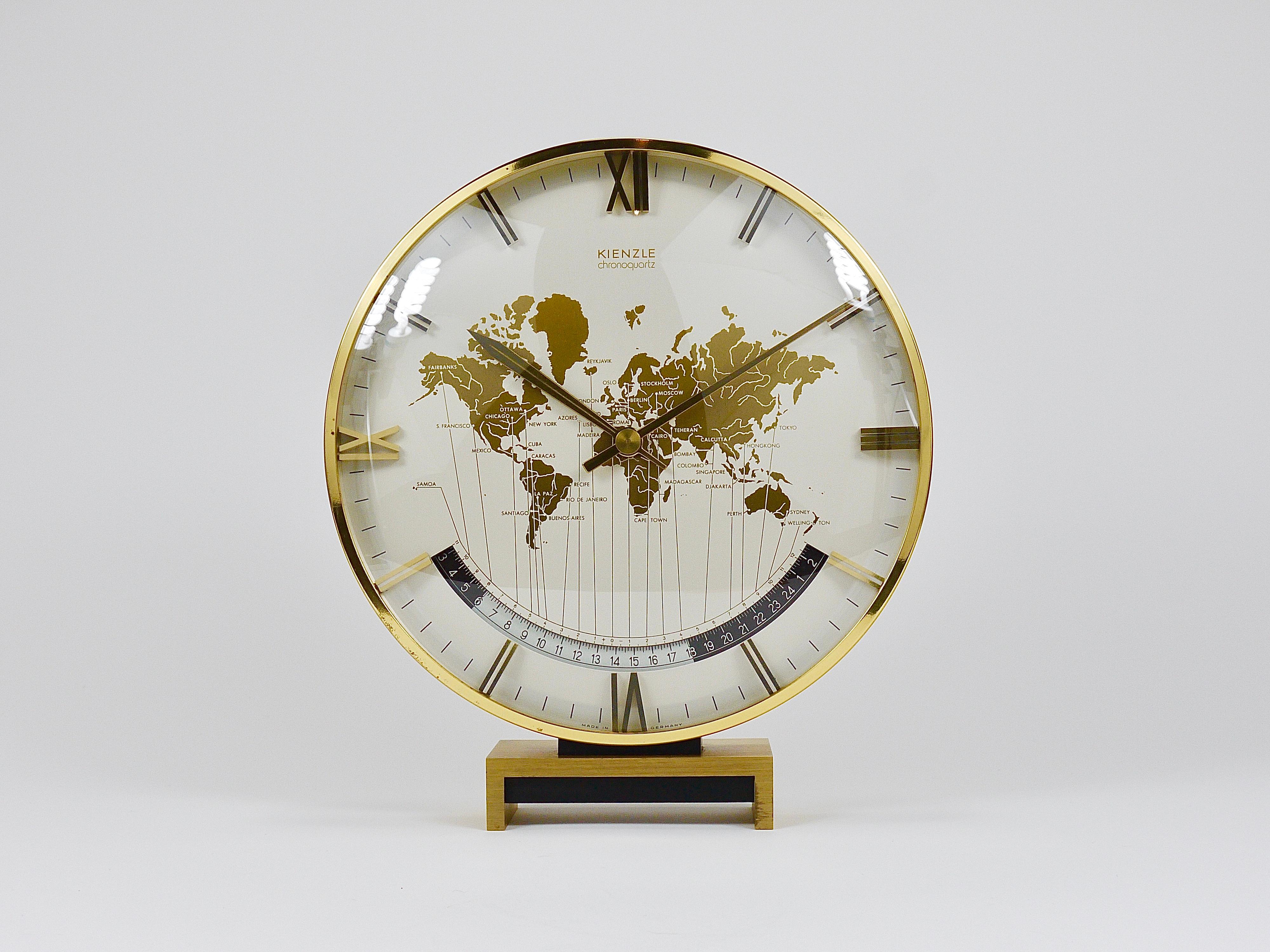 An impressive and large brass-and-glass Kienzle Chronoquartz Mid-Century Modern desk or table clock. This is the largest model available, standing 11 1/2 inches tall. In the style of Heinrich Johannes Möller, the clock features a heavy brass