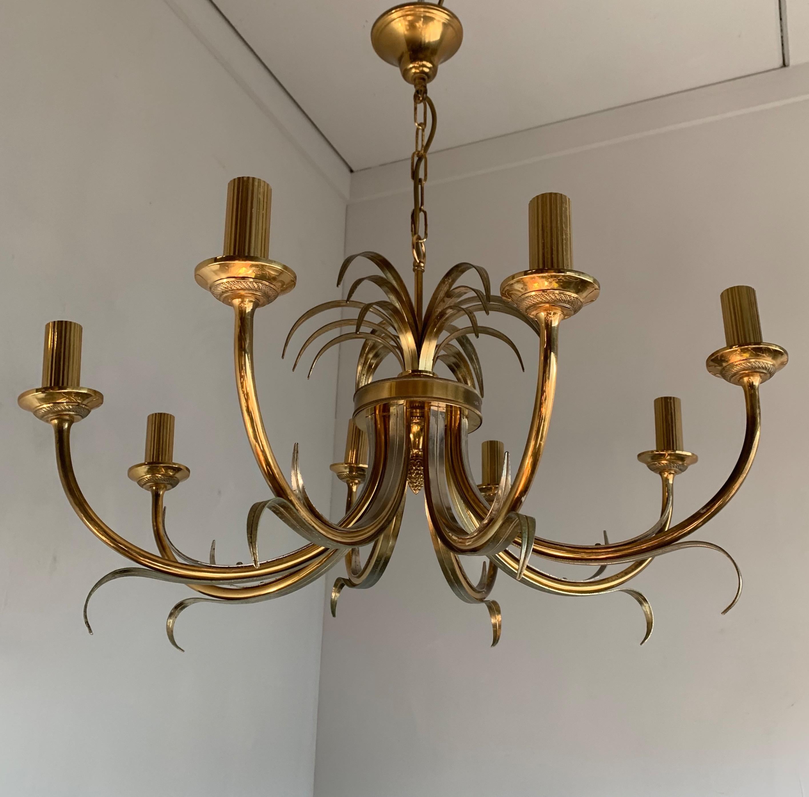 Stunning pair of eight arm brass pendant lights. 

With their elegant shape and shiny golden surface these good size Hollywood Regency fixtures will never fail to impress. Finding this pair more than made our day, also, because we know that