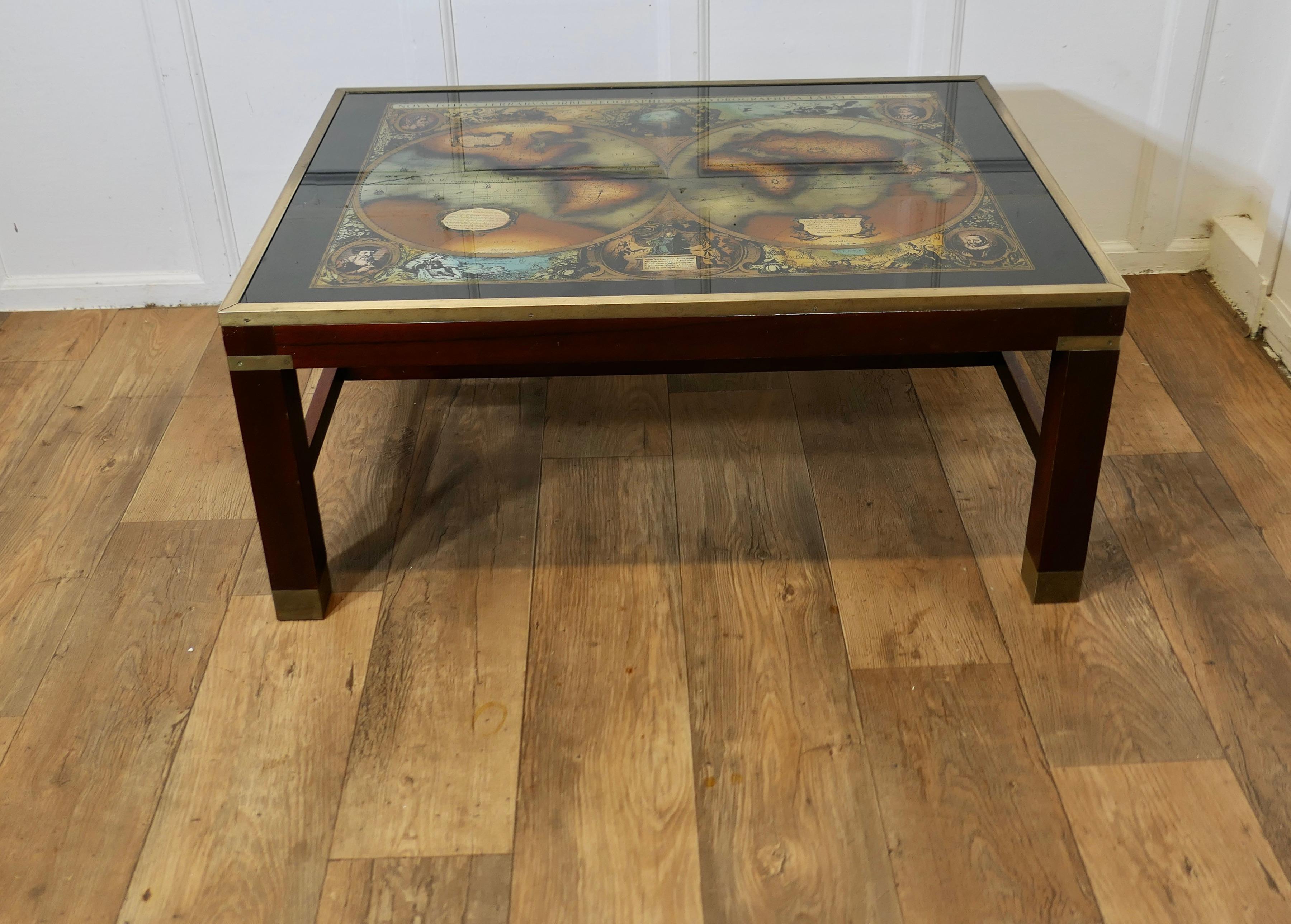 Large Midcentury Maison Jansen Campaign Style Coffee Table

A Stunning Coffee table, the base has brass trim and inlay, the top is a reverse painted glass in black and gold with a Nova Totius Orbis Geographica ac hydrographica tabula