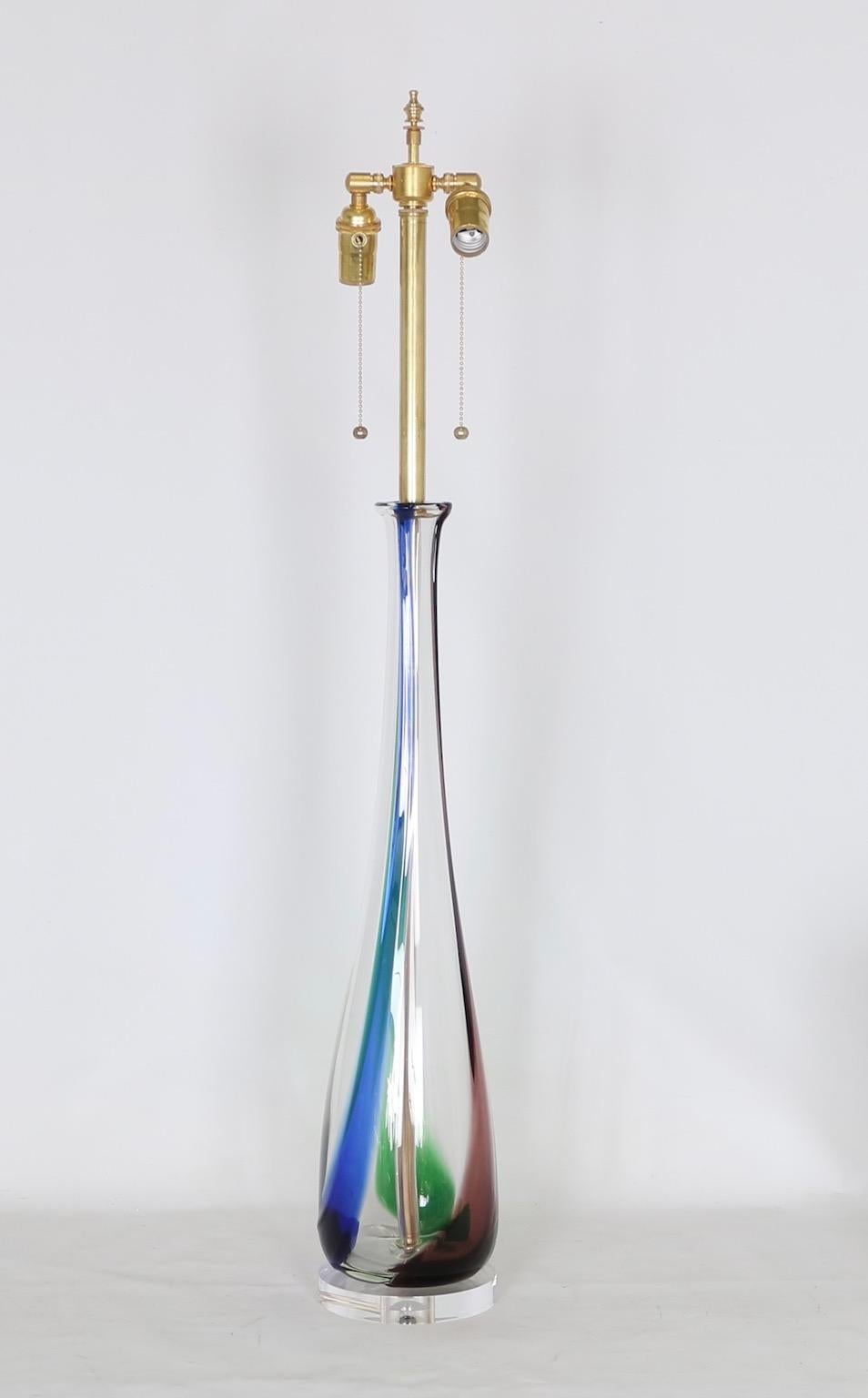 Large Murano glass lamp in clear glass with purple, blue and green stripes, attributed to Dino Martens for Aureliano Toso, circa 1958. This lamp is mounted on a Lucite base and is fully restored with all new wiring and hardware including a double