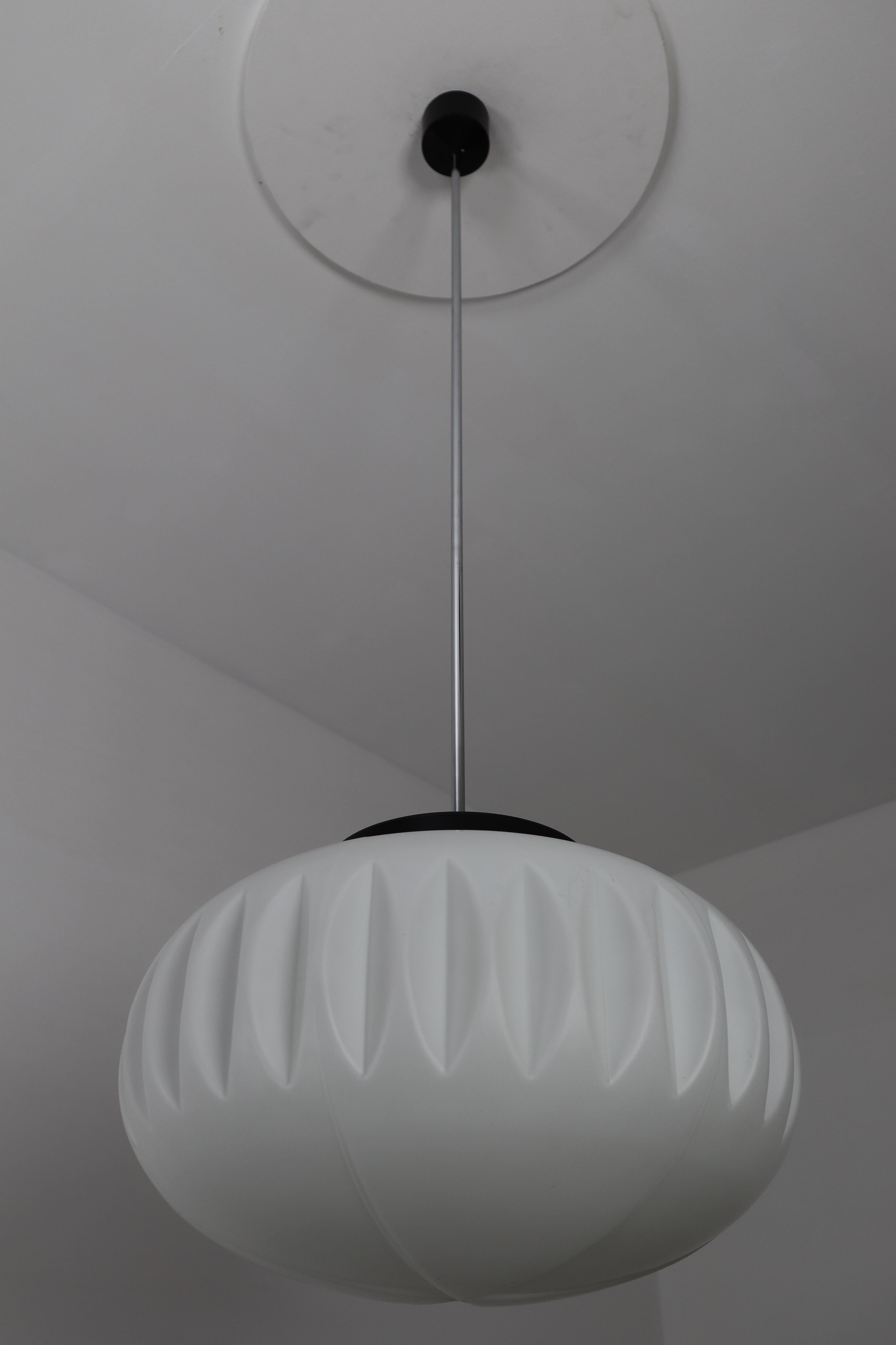Large pendants, opaline glass, Europe, 1960s.The diffuse light it spreads is very atmospheric. Completed with the opaline glass and metal frame details, these pendants will contribute to a luxurious character of the (hotel-bar) interior. Fitted with