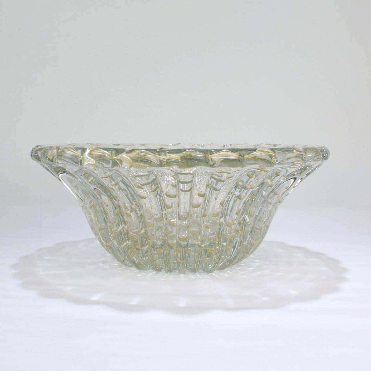 A lovely, large Barovier ribbed Bullicante bowl in clear glass with captured bubbles and gold flake inclusions. 

Of slightly oval form (being just a bit longer than wide).

Simply a great size bowl in a high-quality Mid-Century Modern Italian