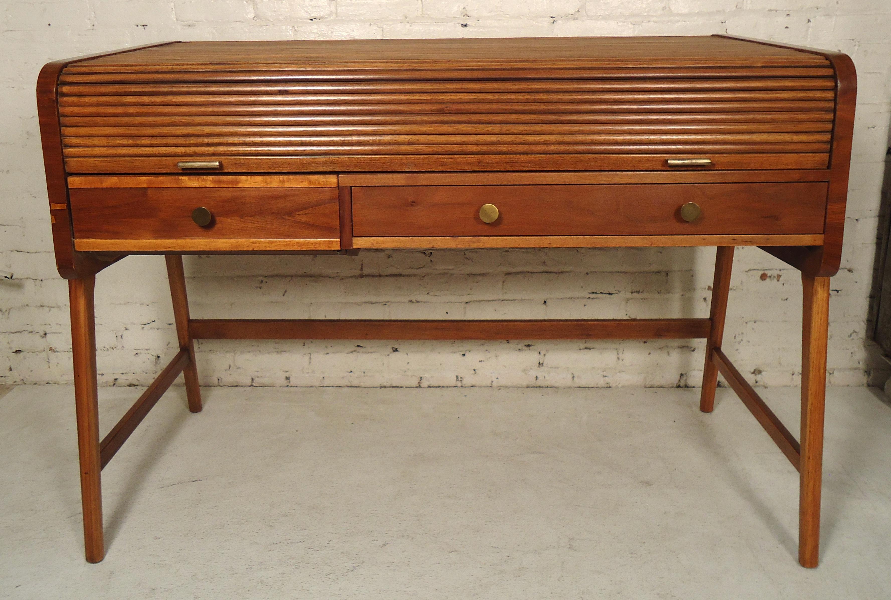 Walnut desk with tambour top that reveals writing top and storage compartments.

(Please confirm item location - NY or NJ - with dealer).
    