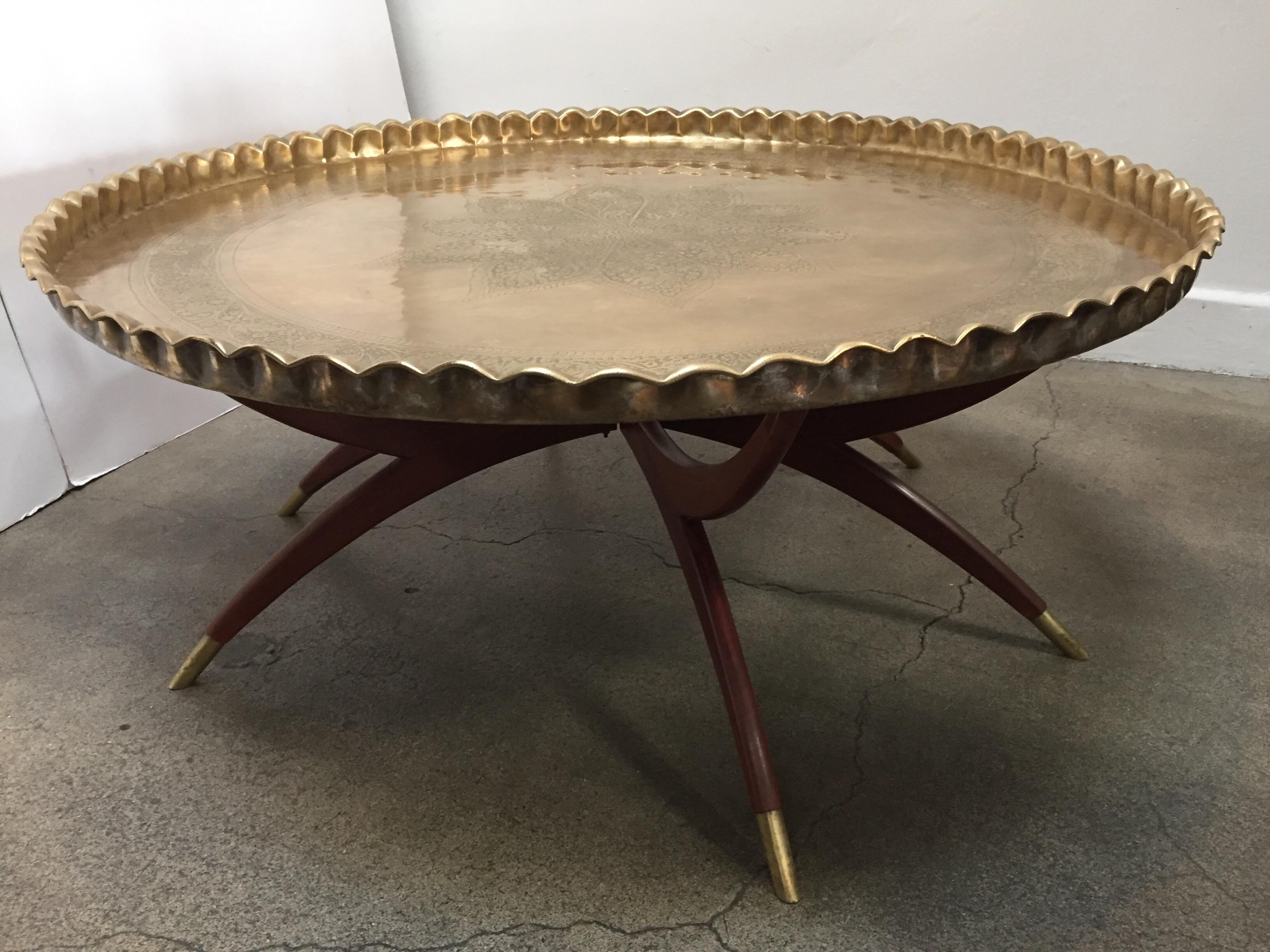 Engraved and embossed large 45 inches round midcentury Anglo Indian brass tray table.
Polished brass Moroccan tray, very good condition, standing on folding mahogany base with six legs.
Very hard to find 45 inches diameter large metal hand-hammered