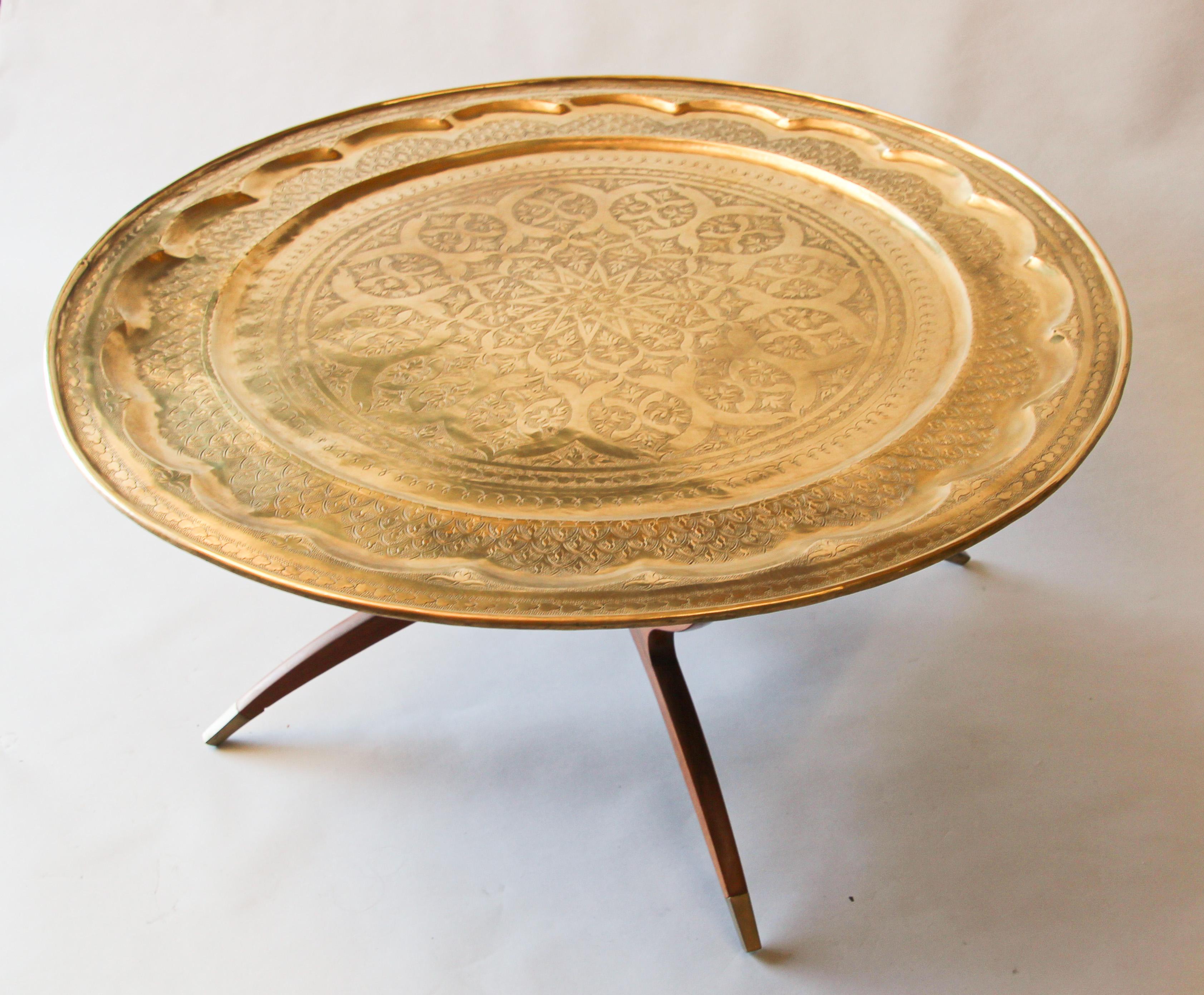 Engraved and embossed large 38.5 inches round midcentury Anglo-Indian brass tray table.
Polished brass Moroccan tray, very good condition, standing on folding wood base with six legs.
Large metal hand-hammered brass tray coffee table.
Middle