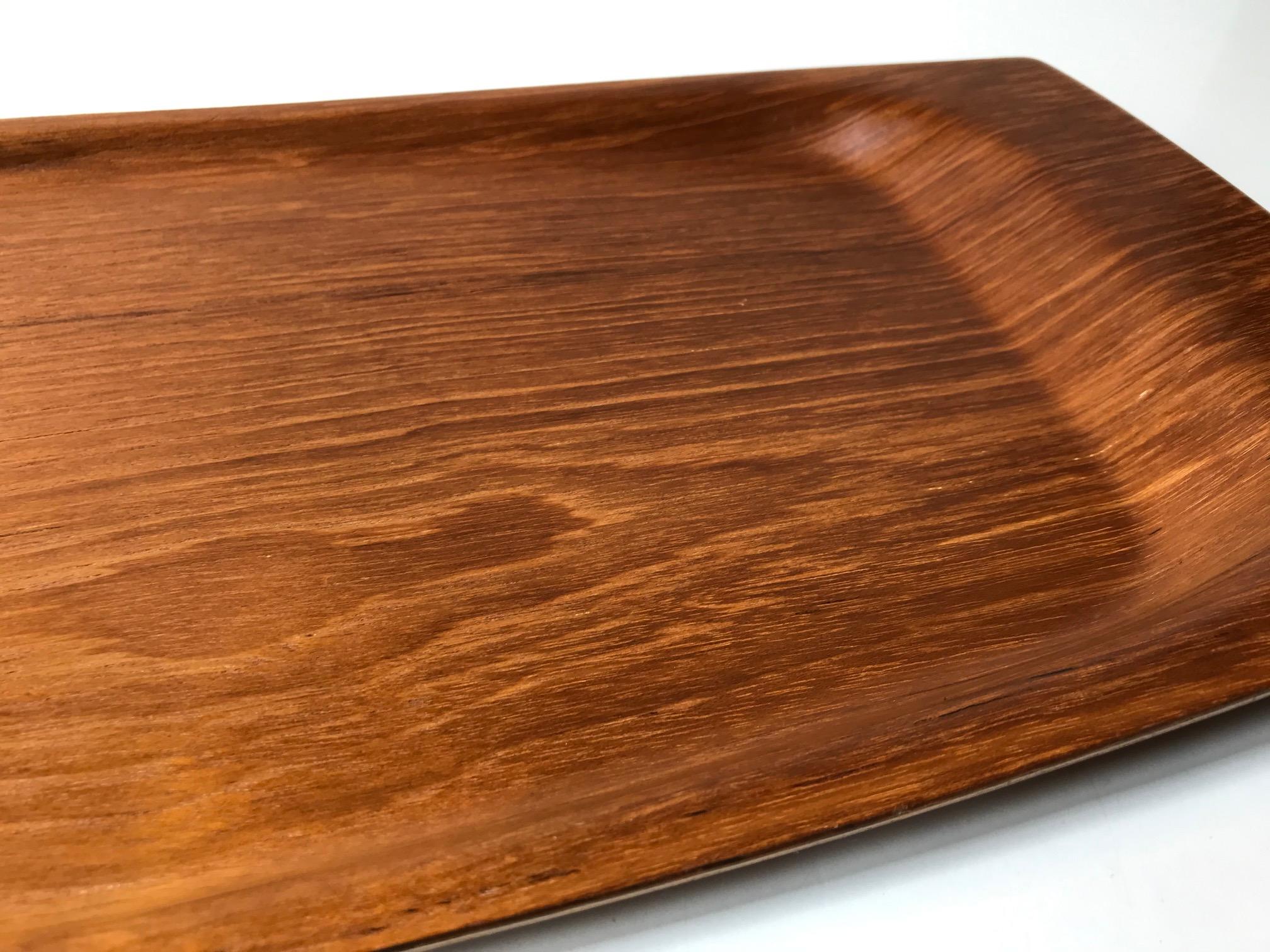 Large serving tray made from teak veneer. Suitable for bed serving set due to its size and raised edges. It was made in Denmark during the 1960s by Langva.