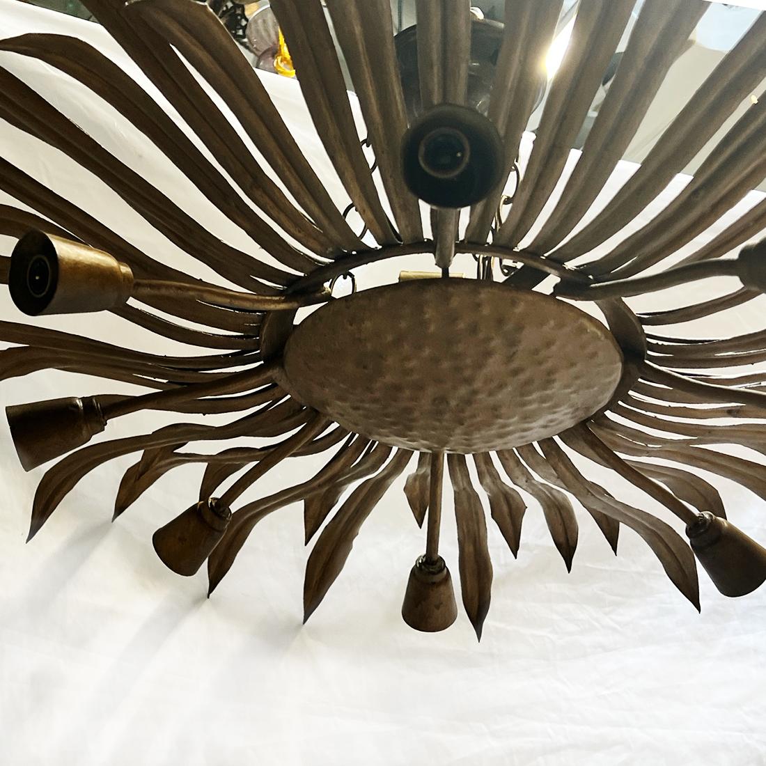 A circa 1960's French gilt metal light fixture with 8 arms and 2 interior lights.

Measurement:
Drop:15