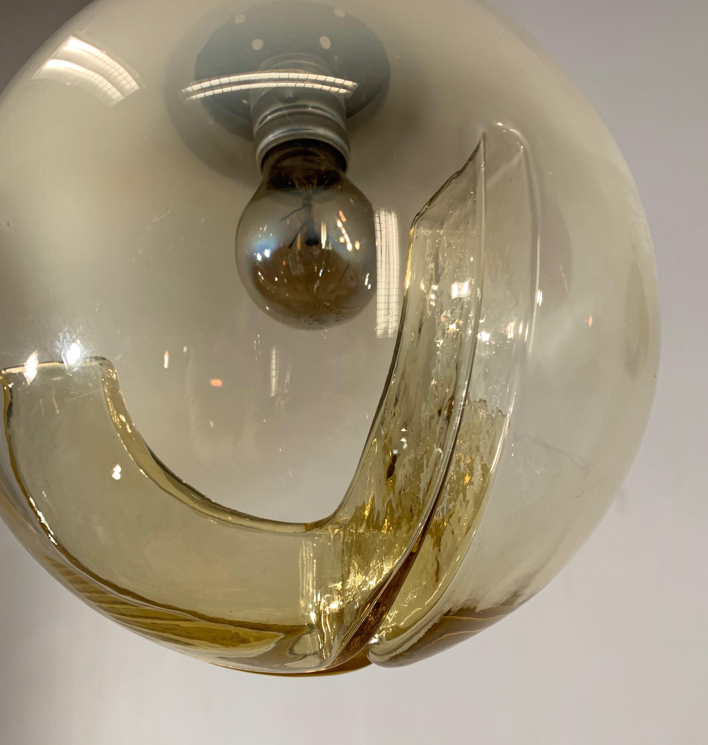 Wonderful and practical glass pendant.

If you are looking for a rare and voguish fixture to grace your home then this handcrafted midcentury light could be your perfect lighting solution. One of our specialities is early 20th century light