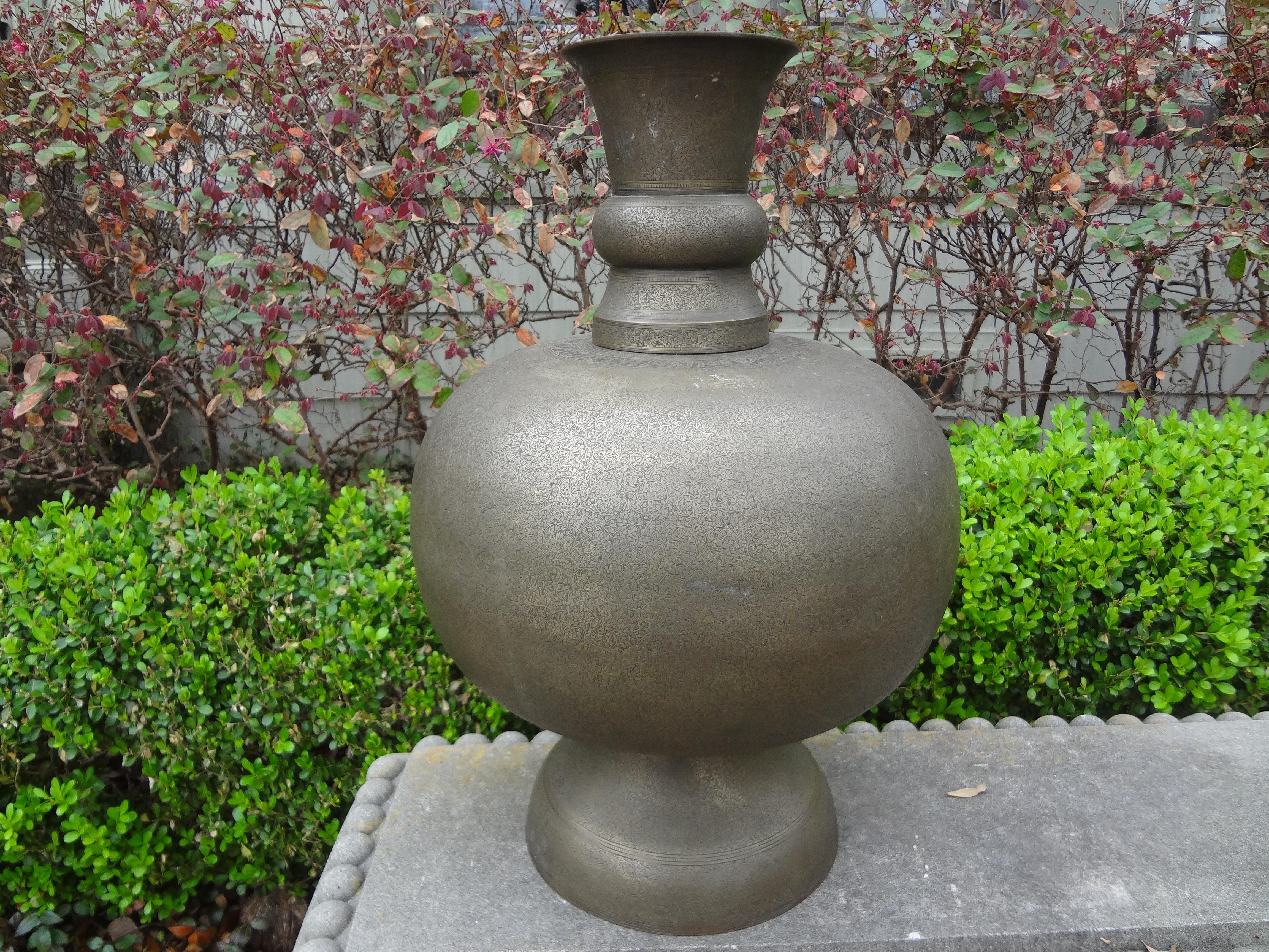 Large middle Eastern Arabesque style etched brass urn.
Stunning huge middle Eastern Arabesque style hand etched brass urn, vessel or vase. This gorgeous heavy weight Moorish style brass urn has intricate etching with writing across the top section.
