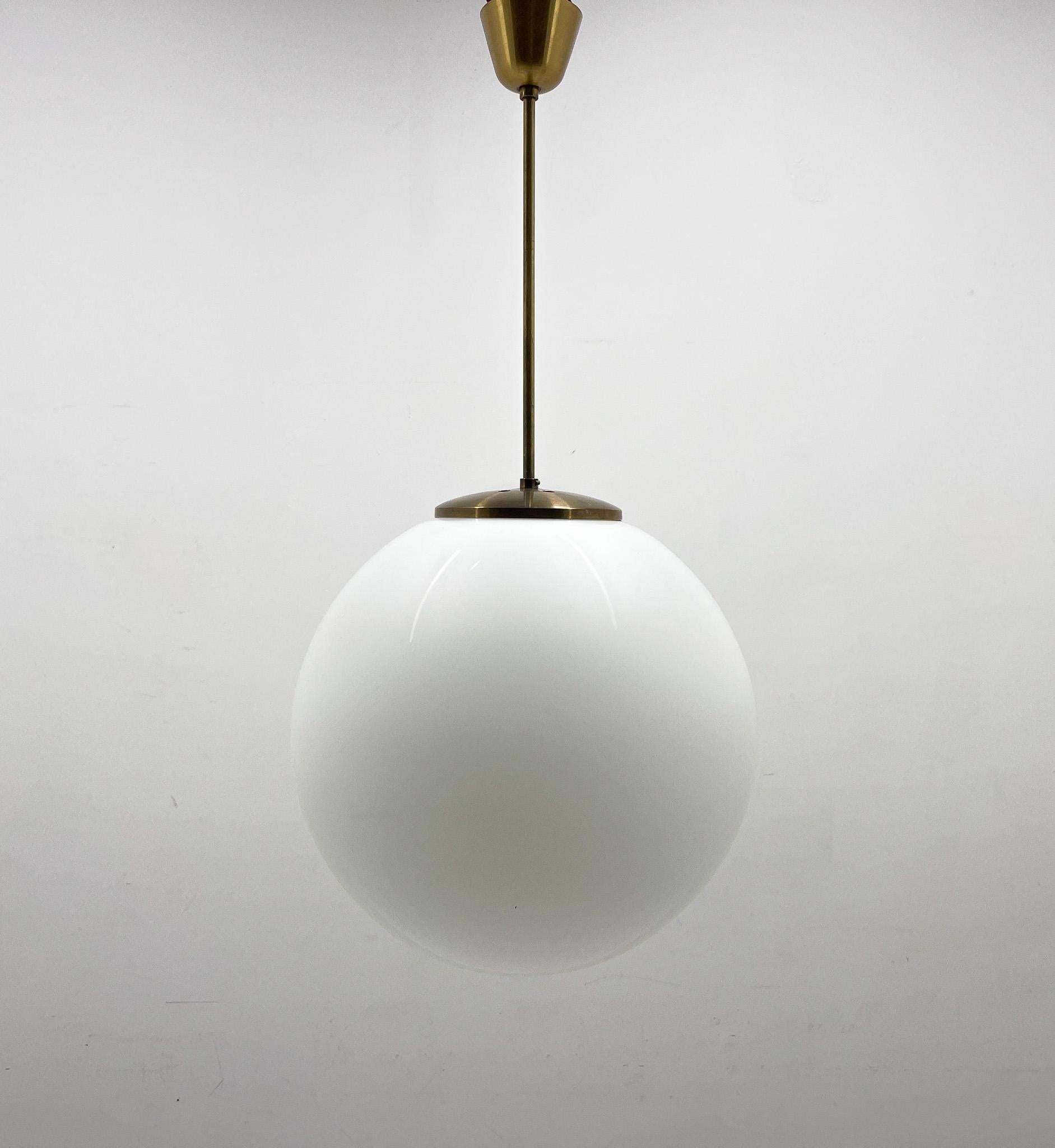 Mid-century large milk glass ball pendant light. Made by the famous Kamenický Šenov in former Czechoslovakia in the 1970's.