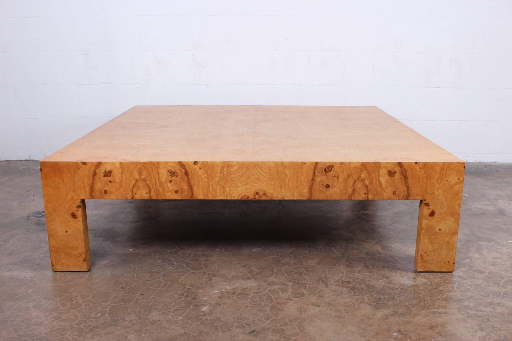 A large burl parsons coffee table designed by Milo Baughman.