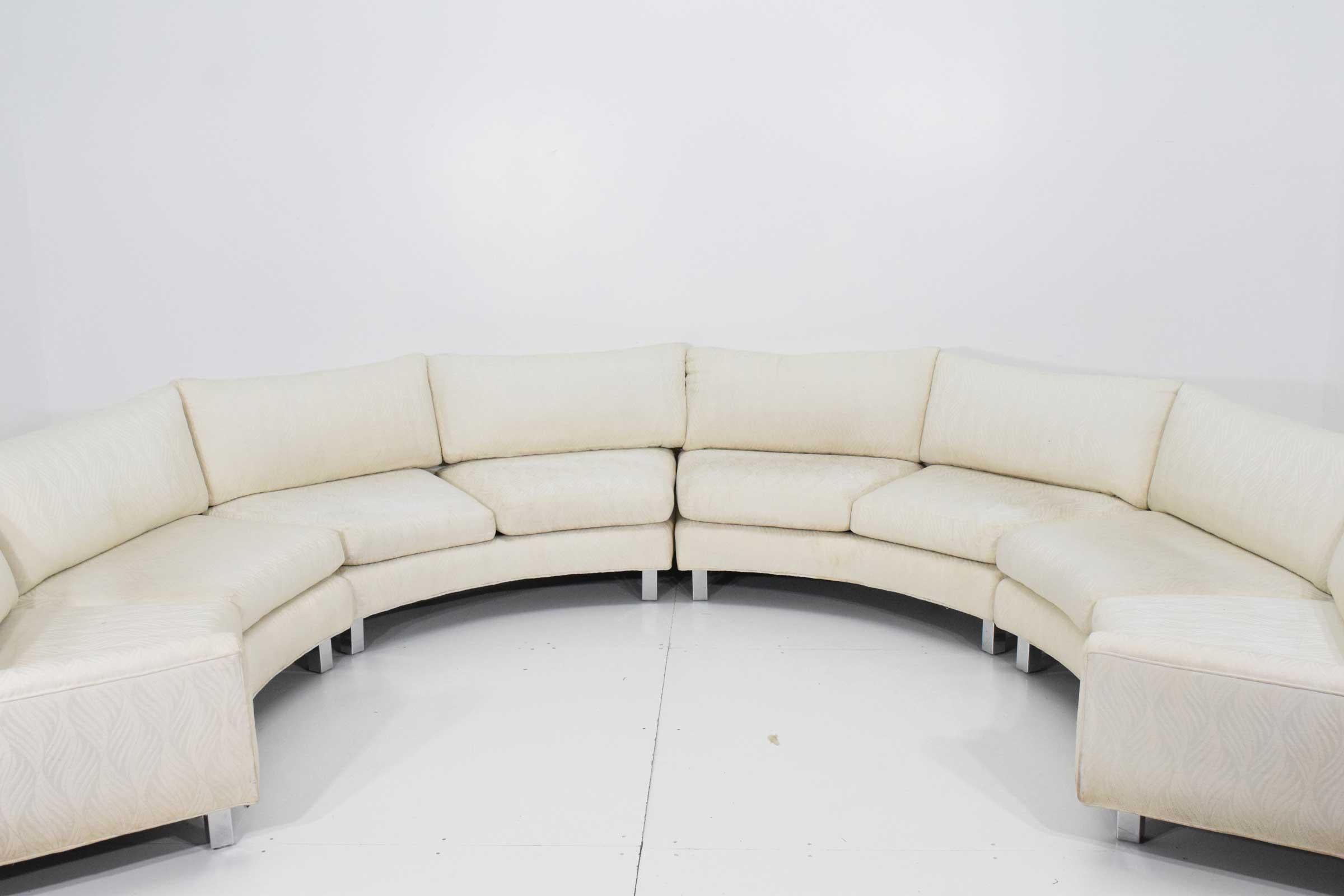 This is a room statement piece. Large four section Milo Baughman circular sofa. Raised on chrome legs. Sofa is structurally sound and very comfortable. We recommend new upholstery which we can help with.