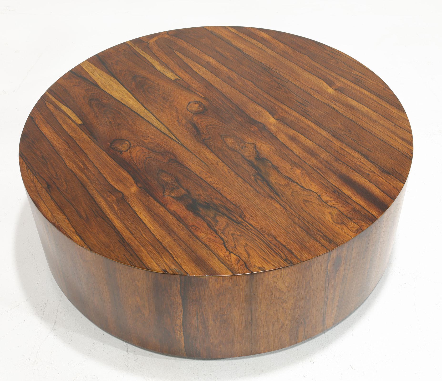 A hard-to-find beautiful rosewood round table by Milo Baughman. The table has beautifully figured graining and rest on a solid black base. 