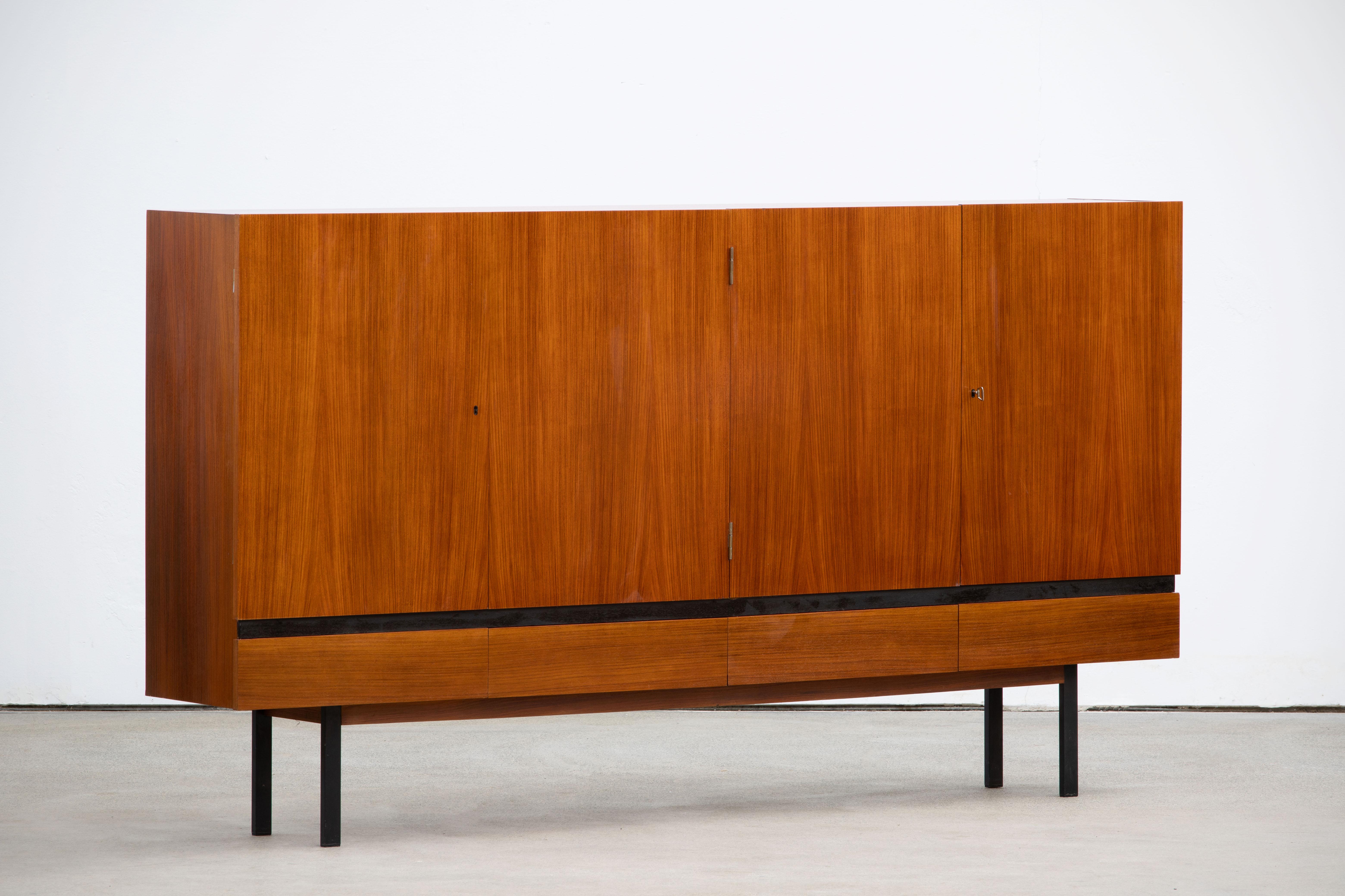 Stunning Minimalist mid-century teak highboard, 1960s, fully lined (four) drawers and stands on nice legs, which makes the whole more elegant.