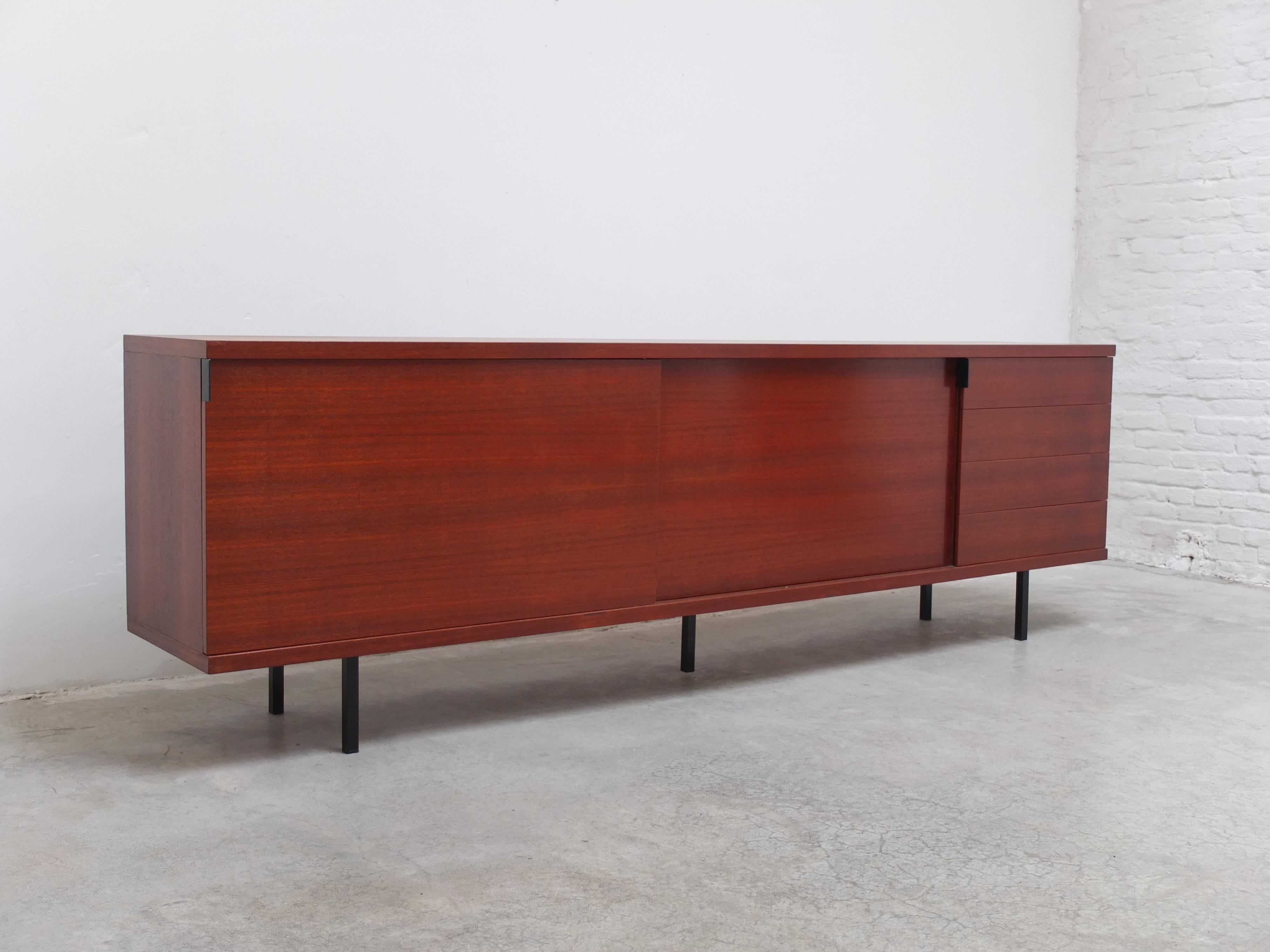 Stunning large sideboard designed by Hans Konëcke for Tecta circa 1960. A very sleek and minimalistic design with sliding doors and 4 drawers in the style of of Florence Knoll. This extra large model is rarely seen and this example is made of teak