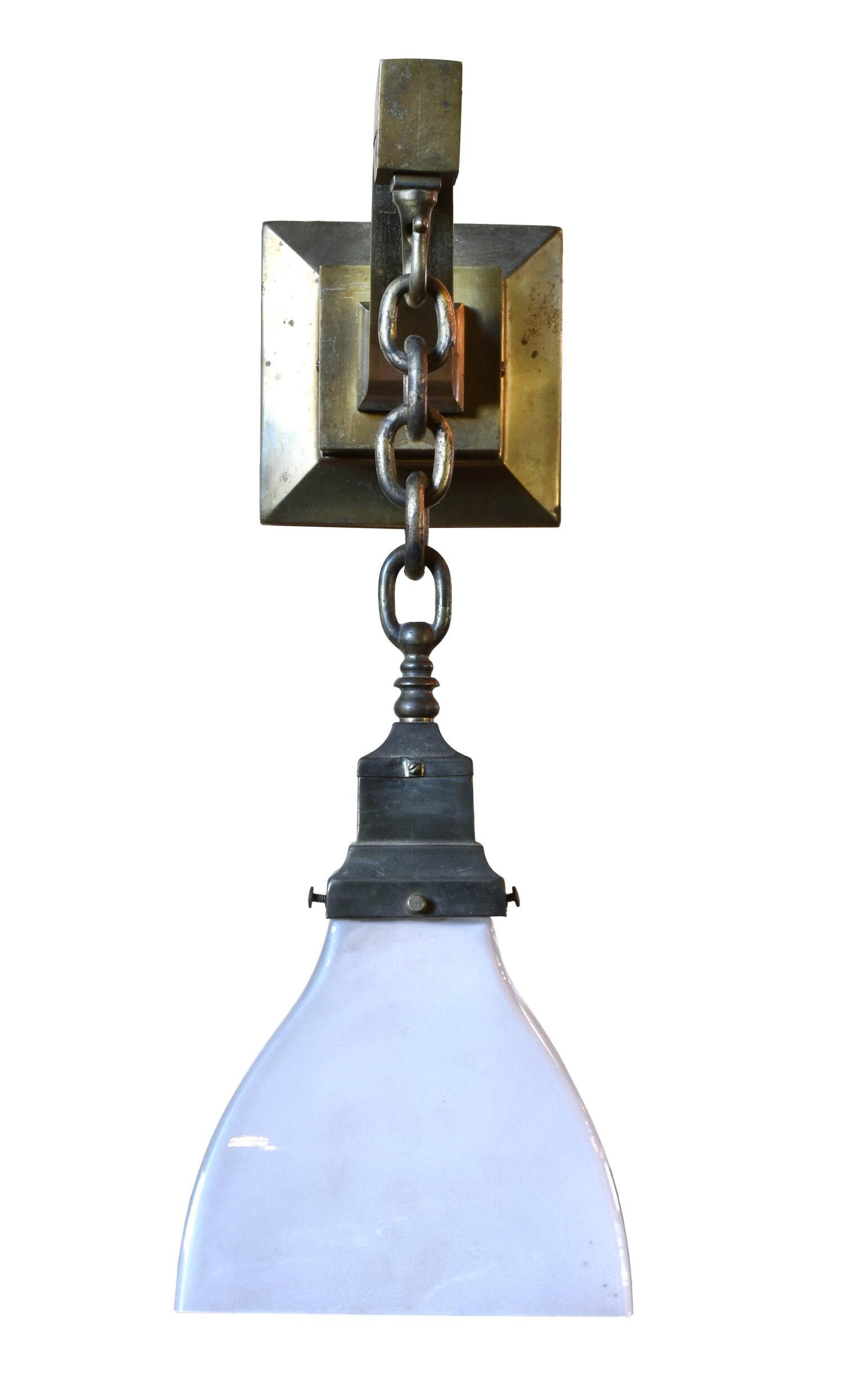 The curved Greek Key arm gives a Neoclassical style to this Mission-style sconce. A large square shade grounds this large light fixture. Perfect simple sconce over a small entry side table. 

Illumination: 1 standard Edison socket 
Measures: 5
