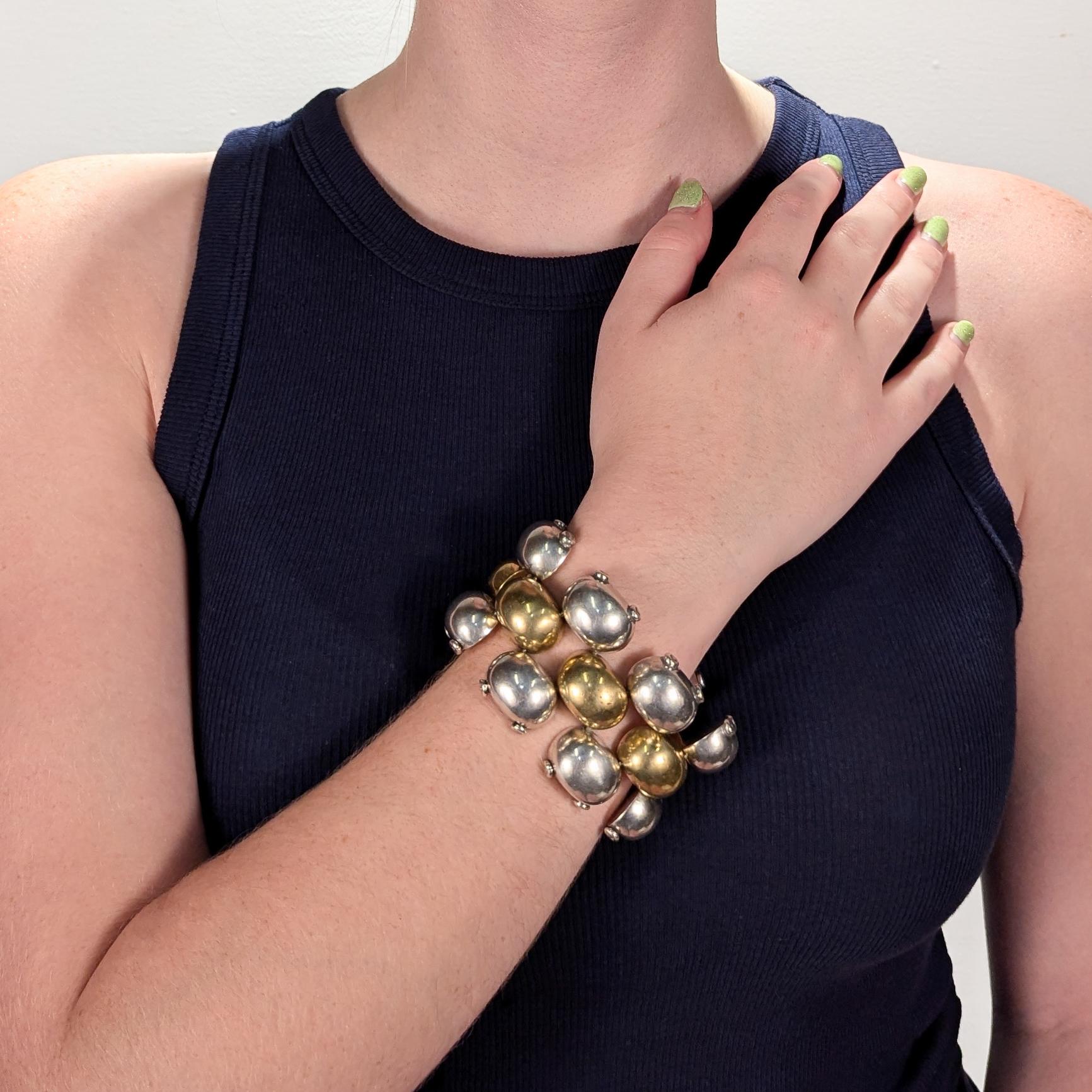 A fine Mexican Mid-Century mixed metals bracelet.

In sterling silver and brass.

Retailed by Laton.

Comprising three robust rows of half round links. The outer rows in in silver with double rivets on their outer flanks and a central row of brass