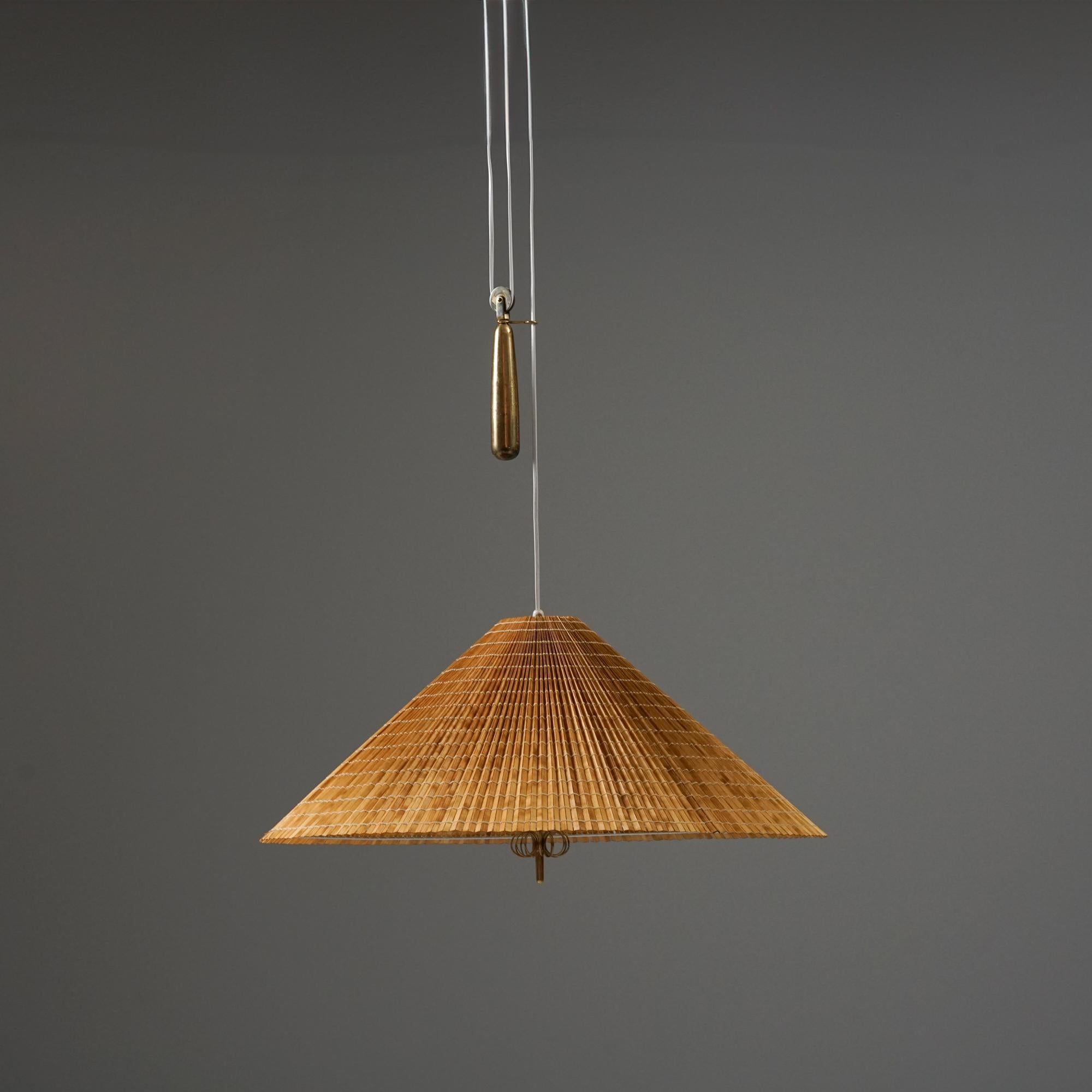 Large model A1967 pendant, designed by Paavo Tynell, manufactured by Taito Oy, Mid 20th-century. Wooden slat shade with glare protection fabric. Brass counterweight. Good vintage condition, minor patina consistent with age and use. The height is