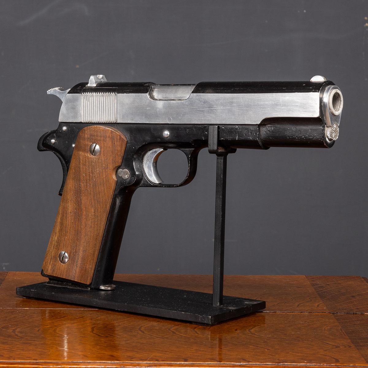 This large model of the M1911, standing over a meter tall, also known as the Colt 1911 or Colt Government for Colt-produced models, stands as an iconic firearm. This single-action, recoil-operated, semi-automatic pistol is chambered for the .45 ACP