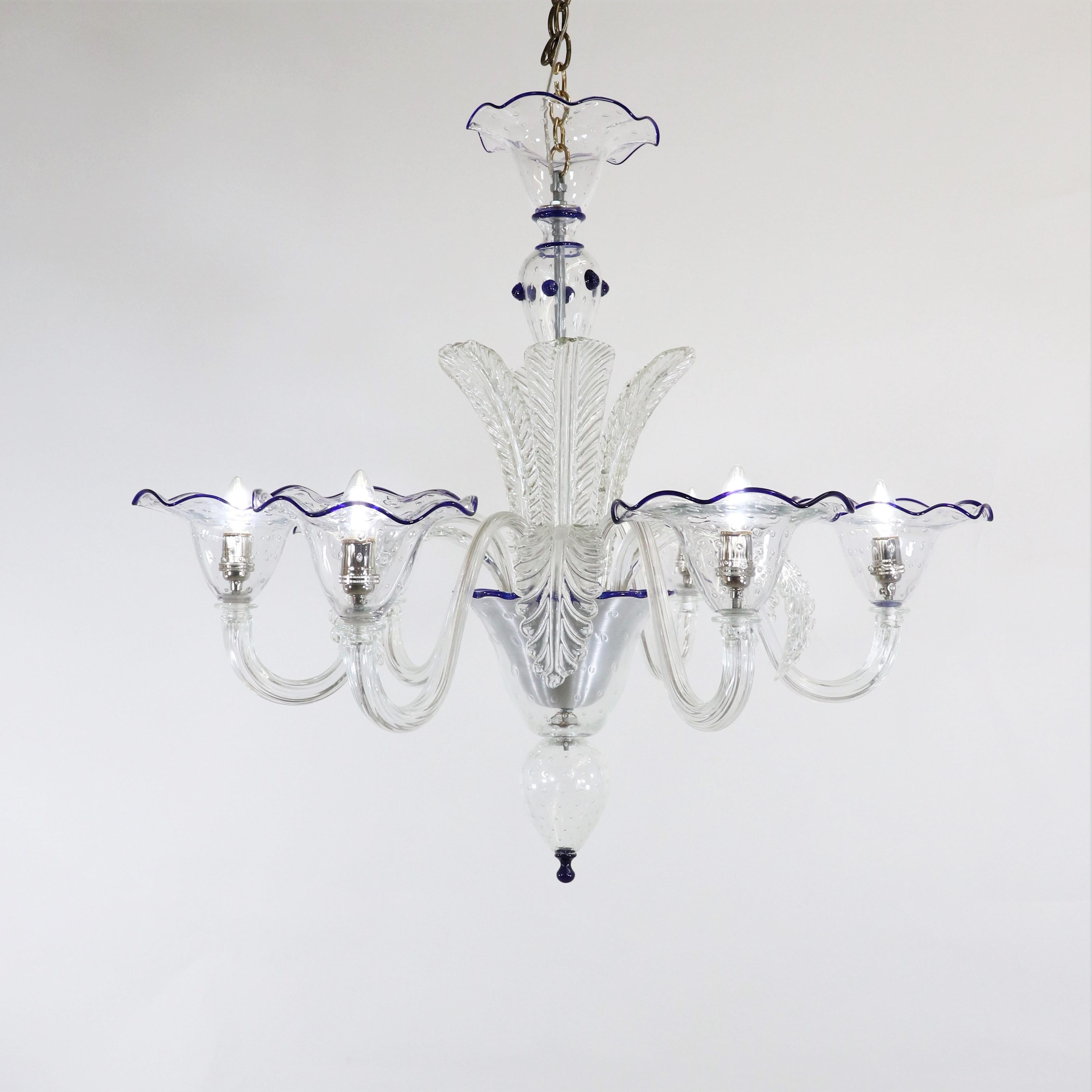 Experience the historical grandeur of this Baroque-inspired modern interpretation Murano chandelier, featuring six gracefully scrolling arms, each adorned with generously sized cups and sprouting fronds at its center. The chandelier's luminous,
