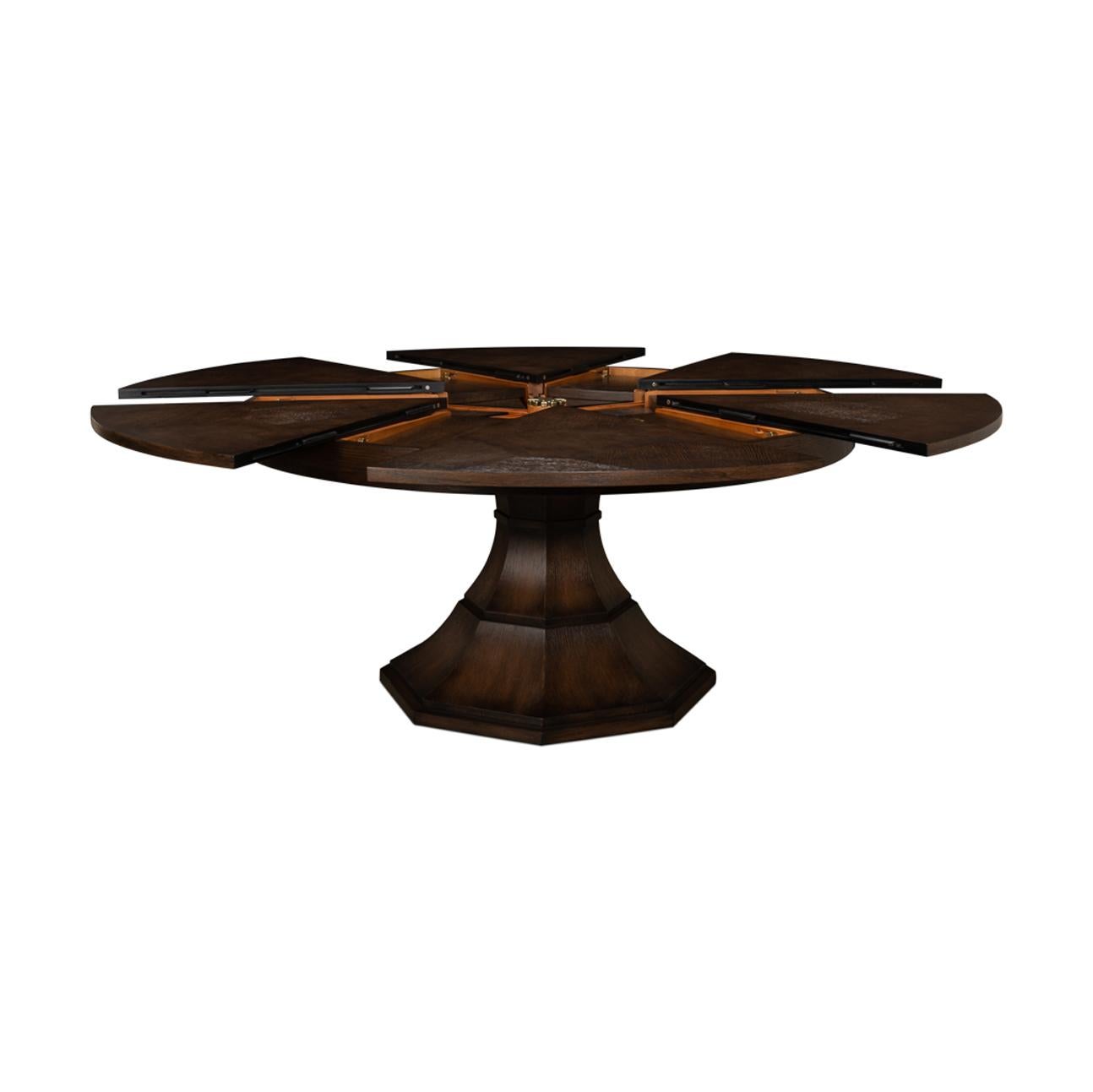 Modern round oak veneered extension Dining Table in a unique burnt brown finish, with self-storing leaves, on a tapered column form pedestal base.

Open dimensions: 84