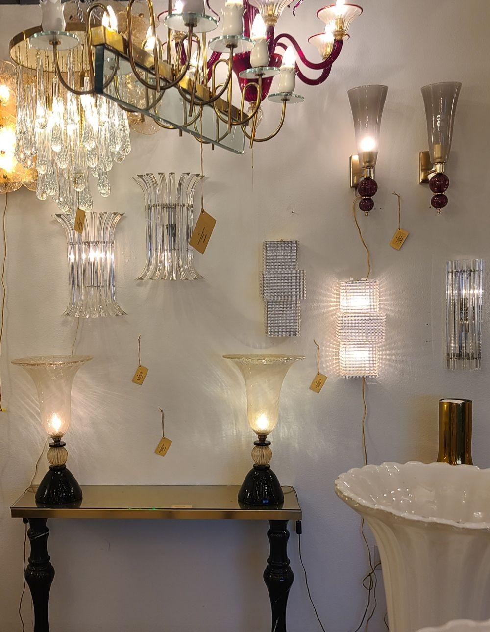 Pair of large Mid Century Modern clear Murano glass sconces, Italy 1970s.
The pair has a geometrical design, with brass fittings.
The clear Murano glass has a grid pattern, making it translucent.
Each sconce has 2 lights, and is rewired for the