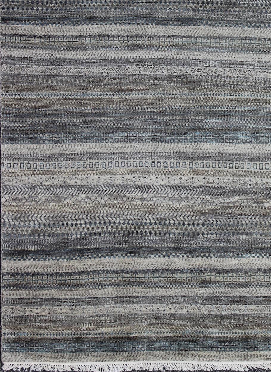 Modern rug in shades of blue, gray, creams, and charcoal modern with a modern striped design, rug KHN-424-TR-154-30 , country of origin / type: India / Scandinavian piled rug.

This Modern Rug is inspired by the work of modernist textile designers