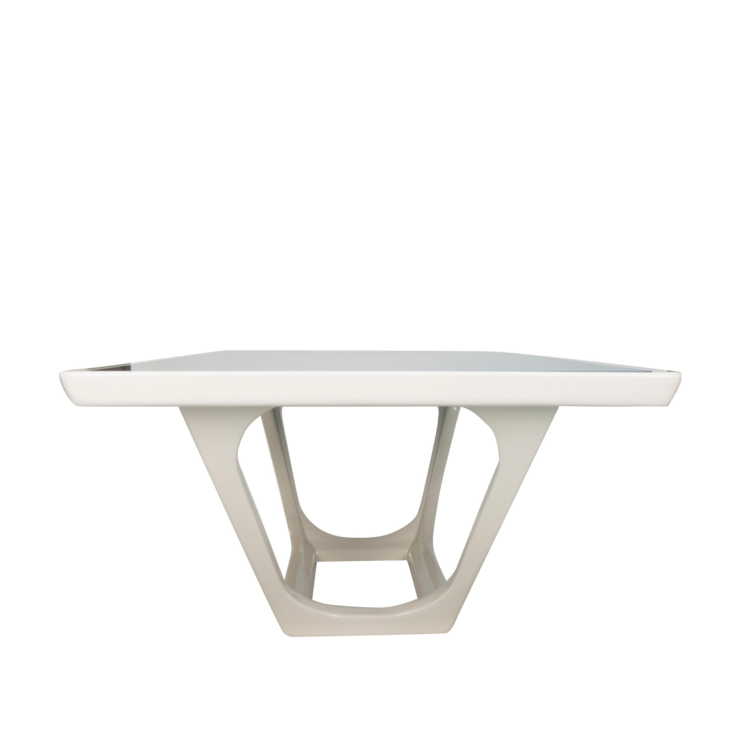 Our Piscina dining table is an original concept inspired by Italian design with simplistic style. The table features a maple frame lacquered in linen white with blue painted glass on top. The base features trapezoidal cutout with rounded edges and a